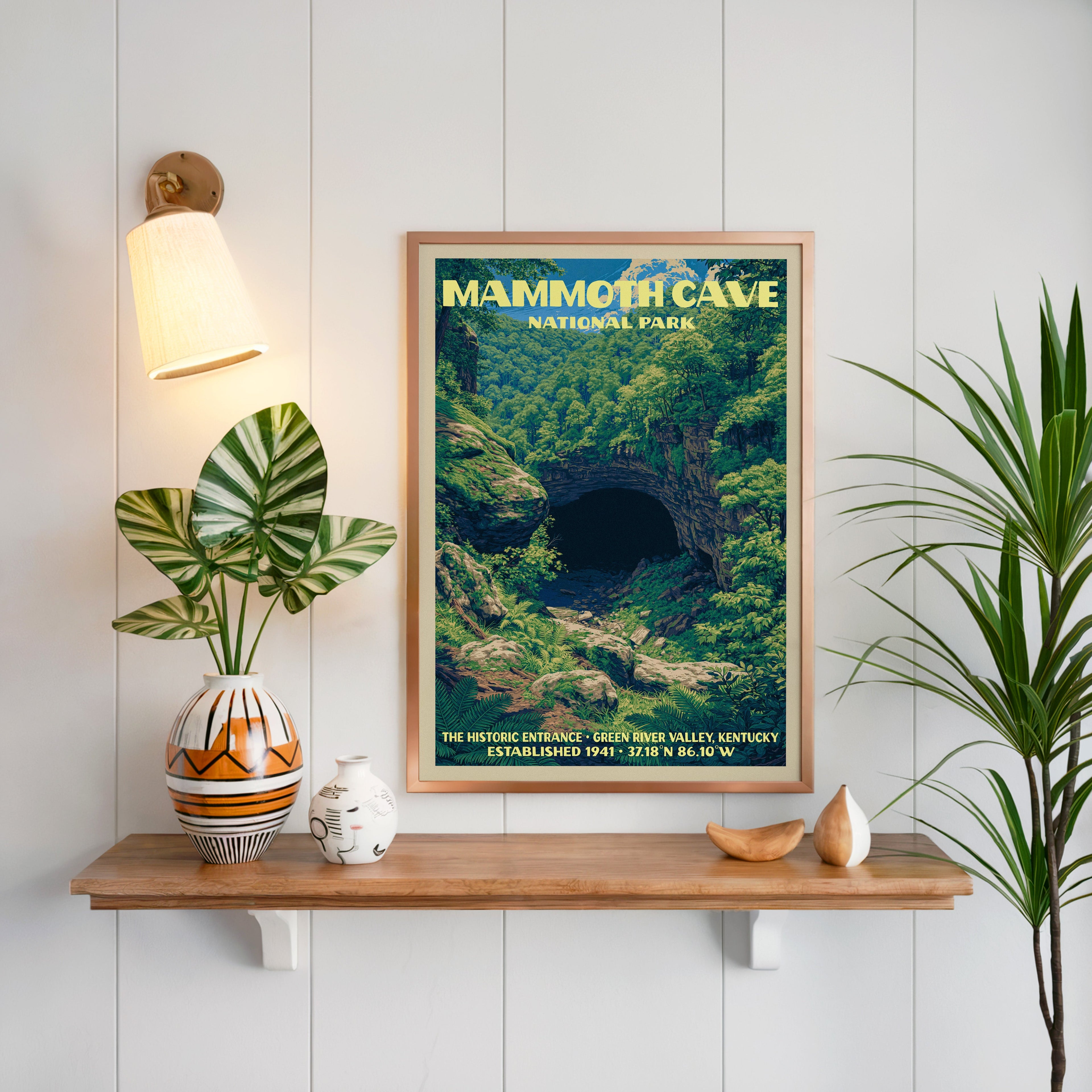 Historic Entrance Mammoth Cave print framed on white panelling above an oak shelf with a patterned vase and sconce