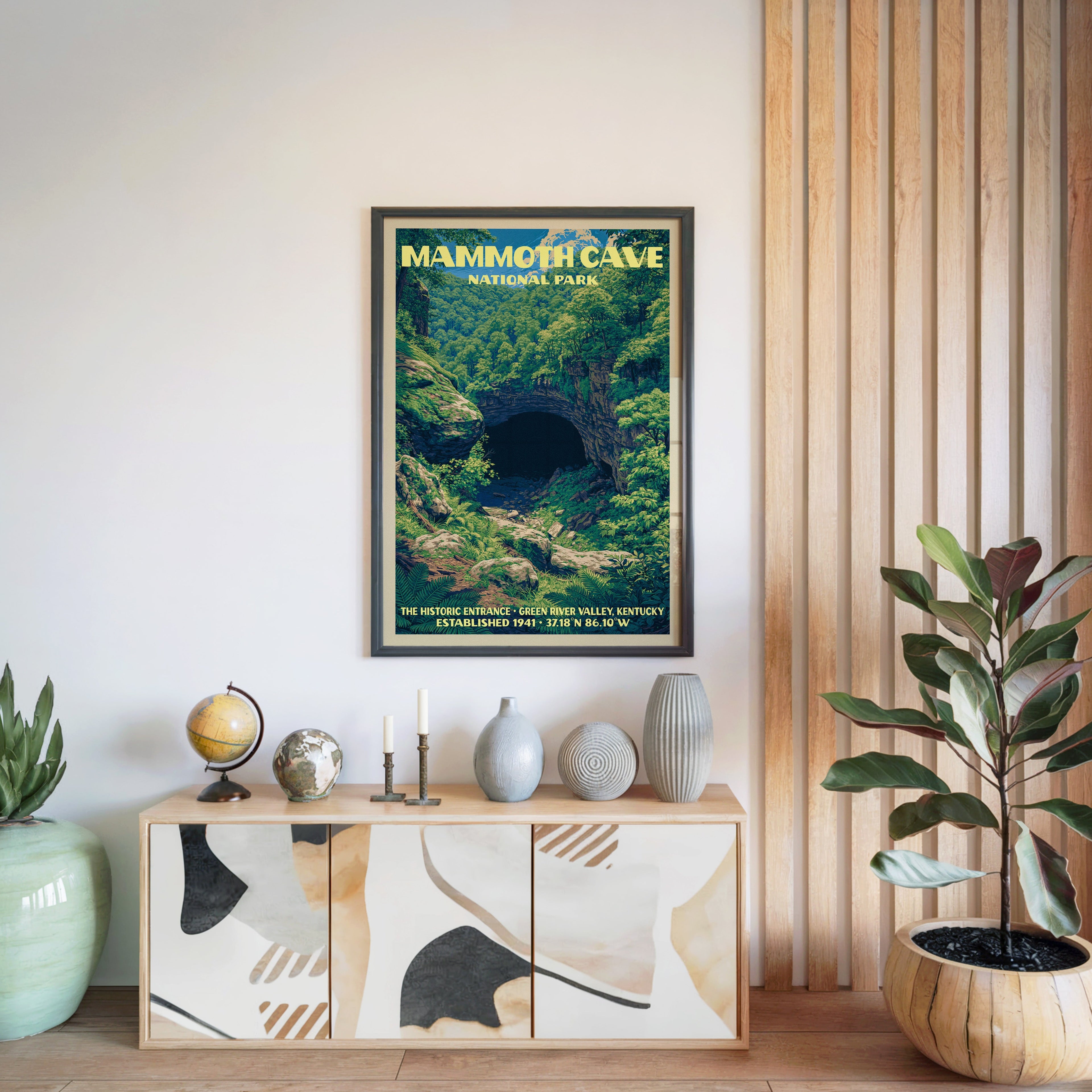 Mammoth Cave National Park poster in a black frame above a light wood sideboard by a slatted wall panel