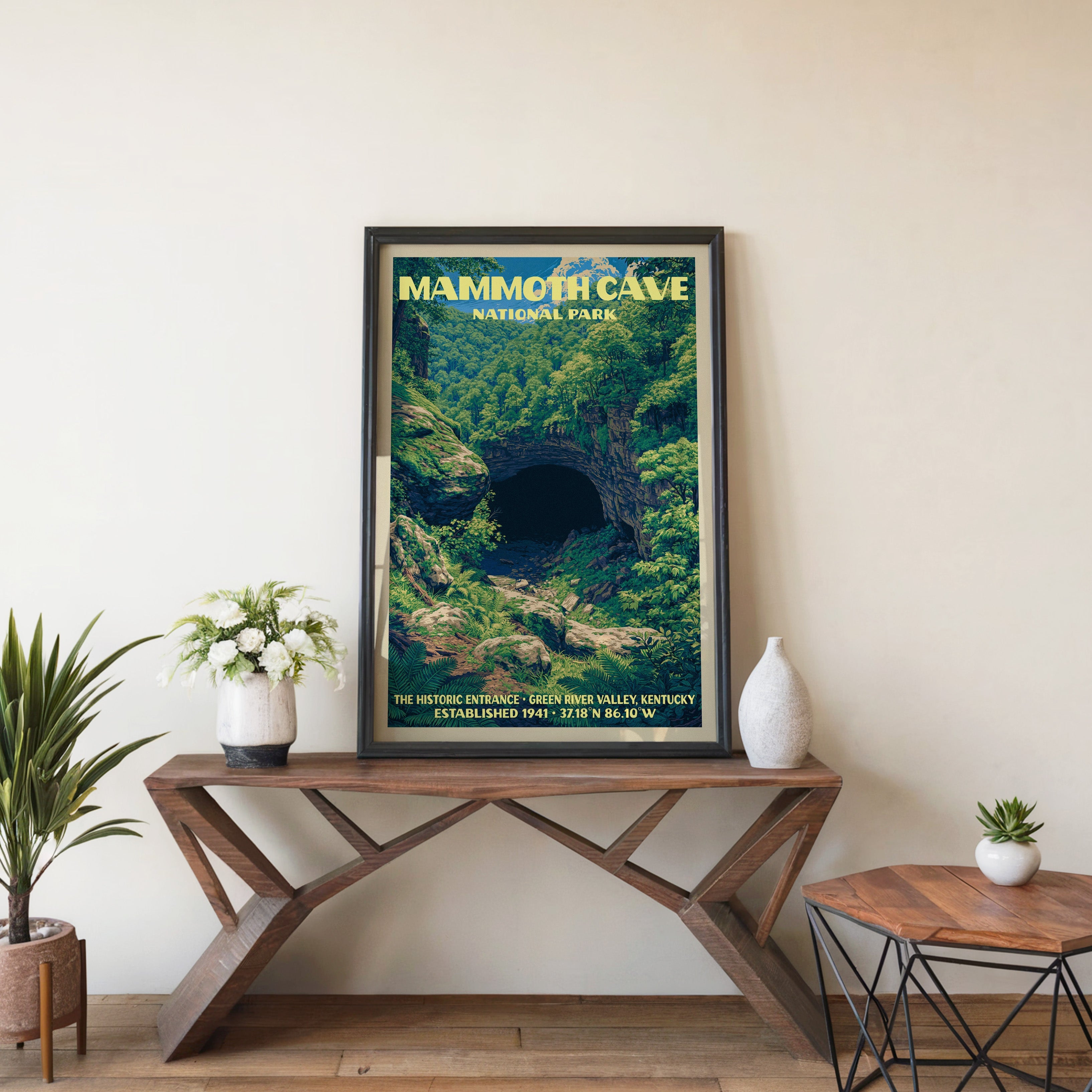 Mammoth Cave Historic Entrance wall art in black, leaning on a walnut console with white anemones and a vase