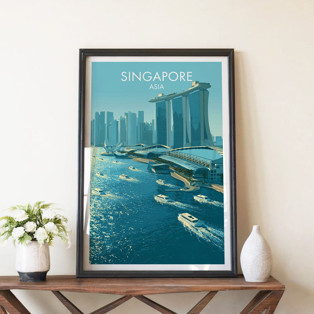 Marina Bay Sands Singapore travel poster in a black frame on a wooden console table with white flowers