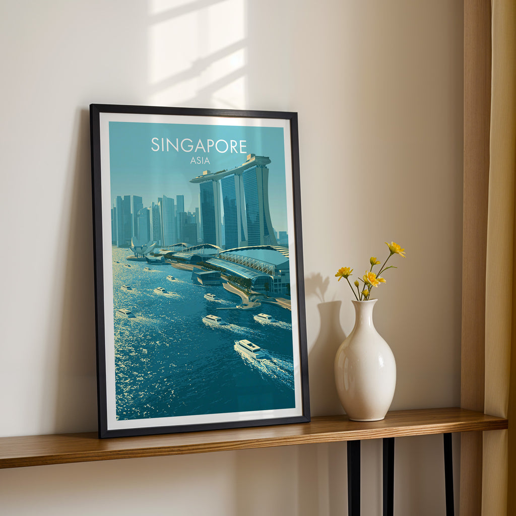 Black framed Marina Bay Sands Singapore print on a narrow hallway console in sunlight, styled with yellow flowers