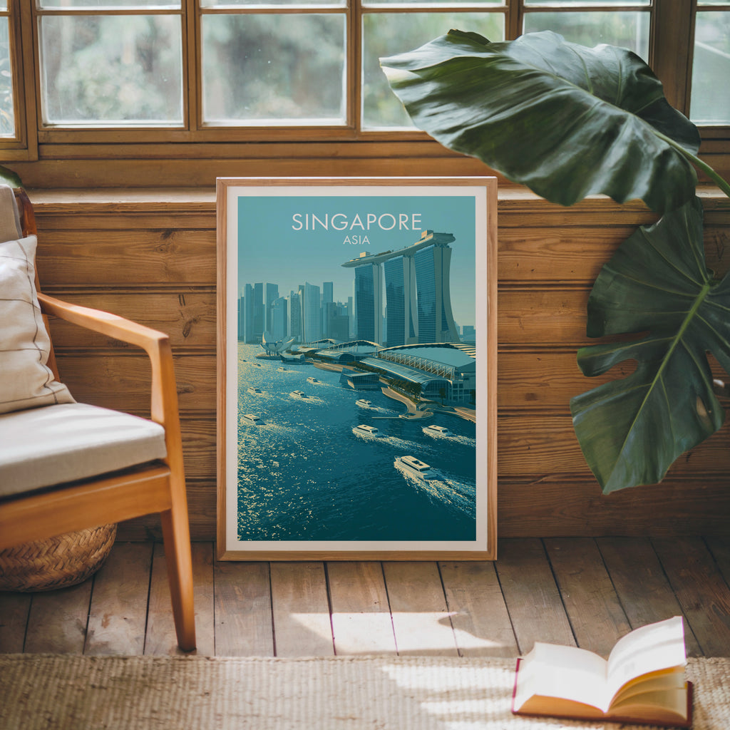 Framed Marina Bay Sands Singapore poster leaning against a timber cabin wall with monstera leaves and an open book