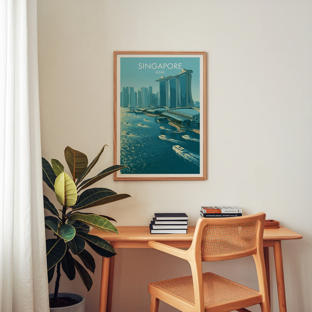 Marina Bay Sands Singapore wall art above a wooden home office desk with a rattan chair and books