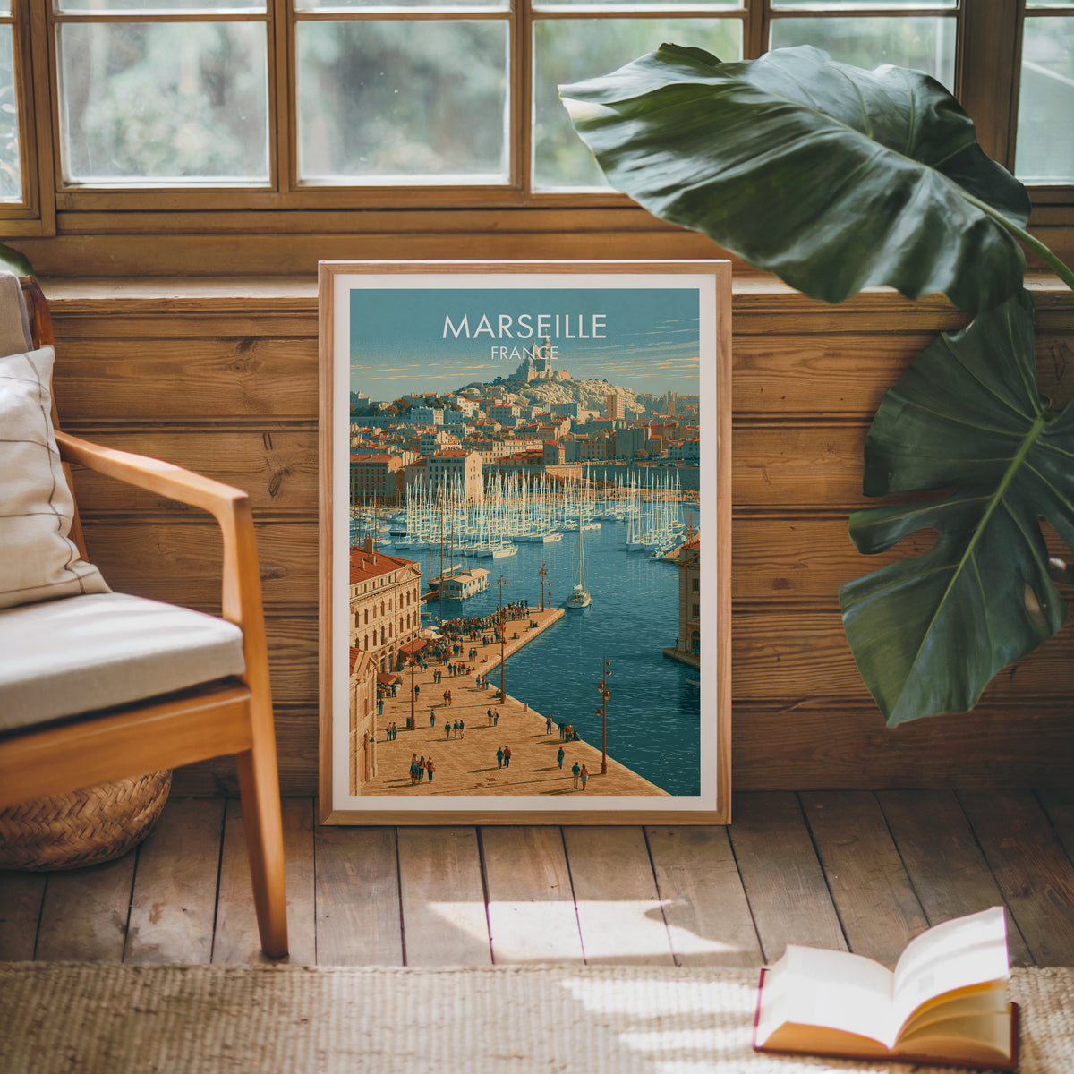 Marseille travel poster, oak frame leaning on a wood-panelled sunroom wall by a mid-century armchair