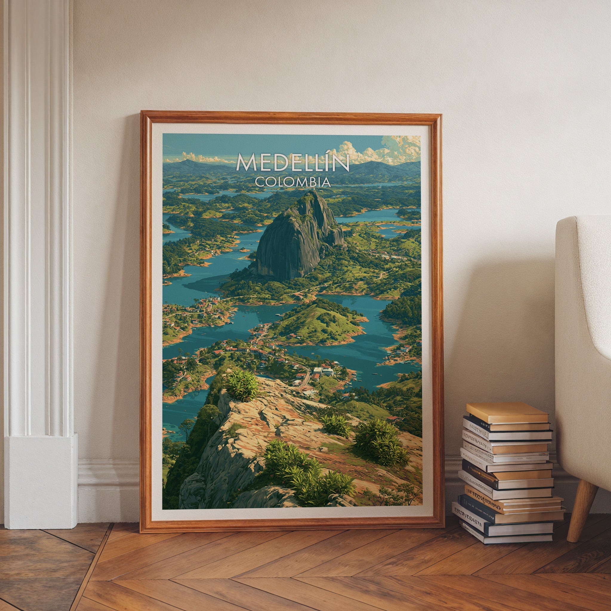 Colombia travel print in a walnut frame on a herringbone floor by white wall moulding, book stacks and an armchair