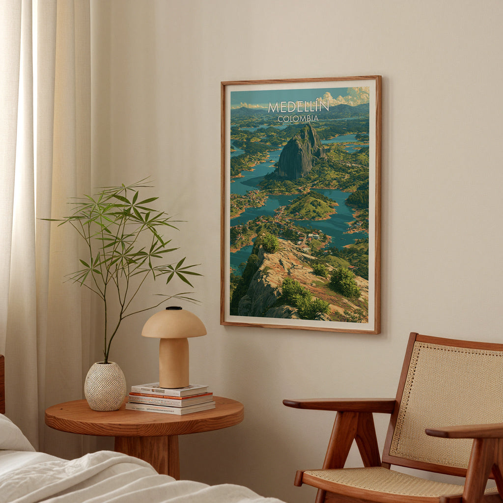 Teal water and islands wall art in a walnut frame in a bedroom above a round nightstand with a terracotta lamp