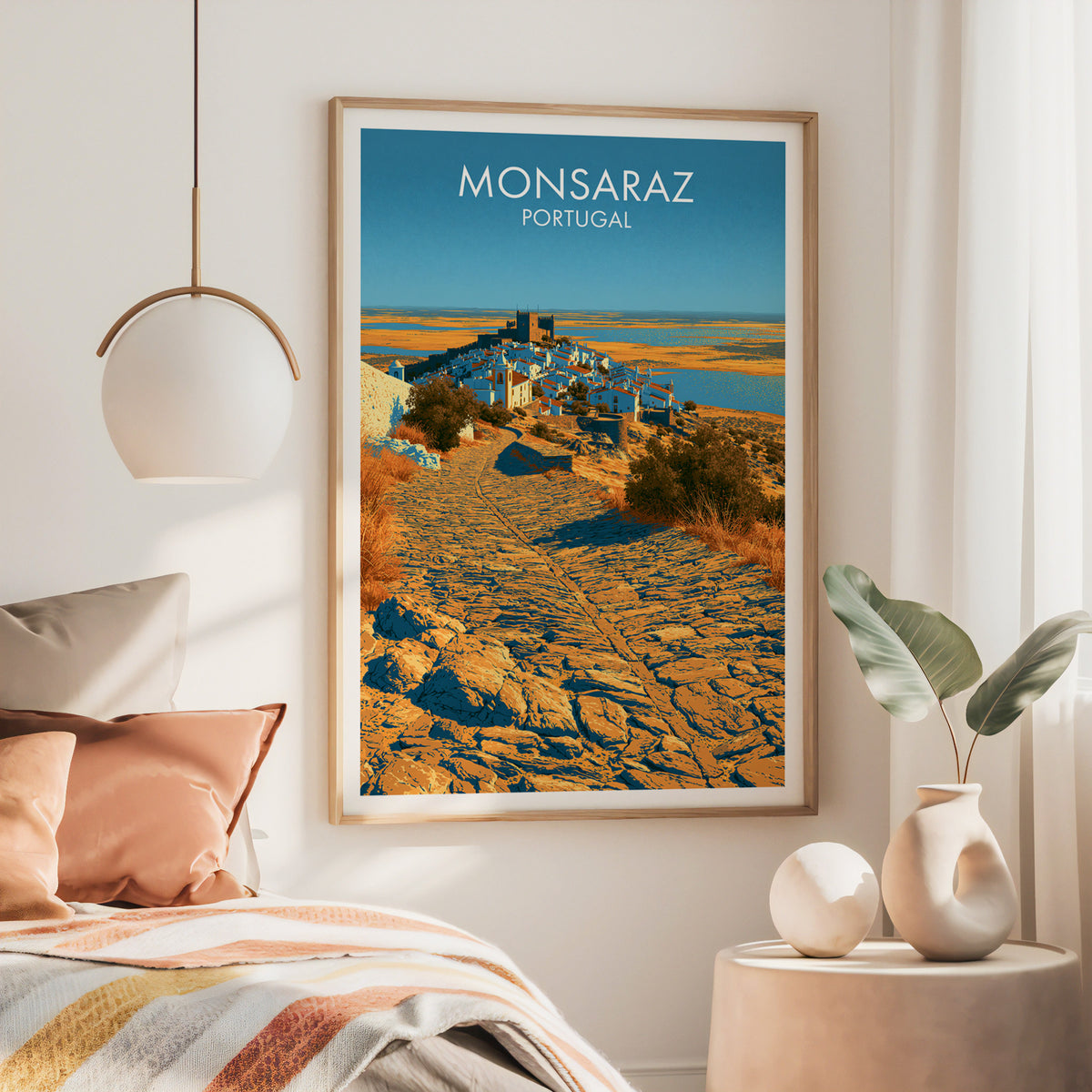 Monsaraz Portugal wall art, large oak frame above a bed with rust bedding and a brass globe pendant