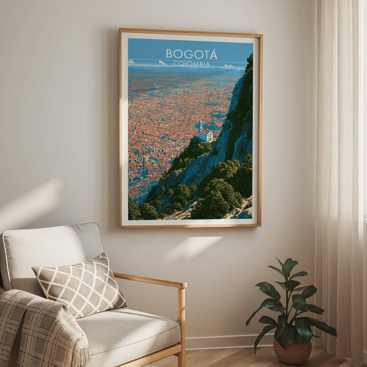Monserrate ridge print in an oak frame above a cream armchair with a checked cushion, sheer curtains and a plant