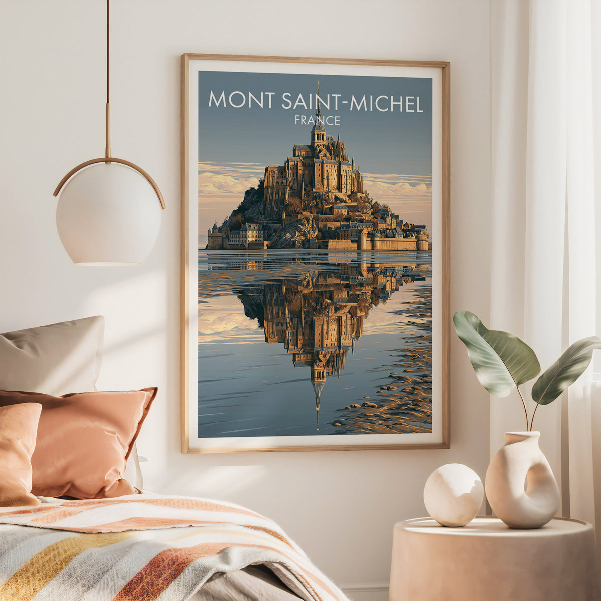 Mont Saint-Michel poster in a large oak frame above a bed with rust bedding, under a brass lamp