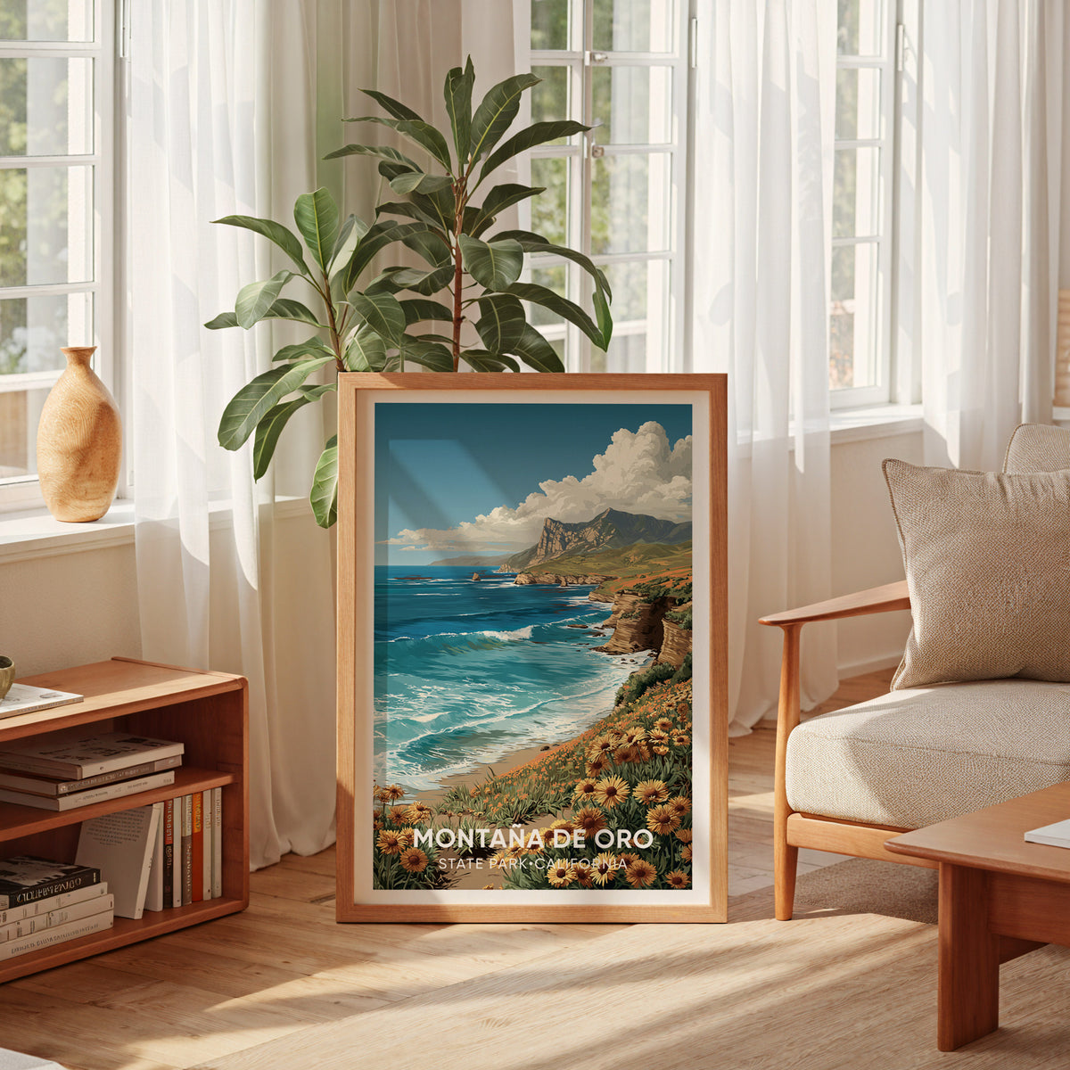 Montana de Oro framed print resting on the floor by a sheer-curtained window, low bookshelf and cream armchair
