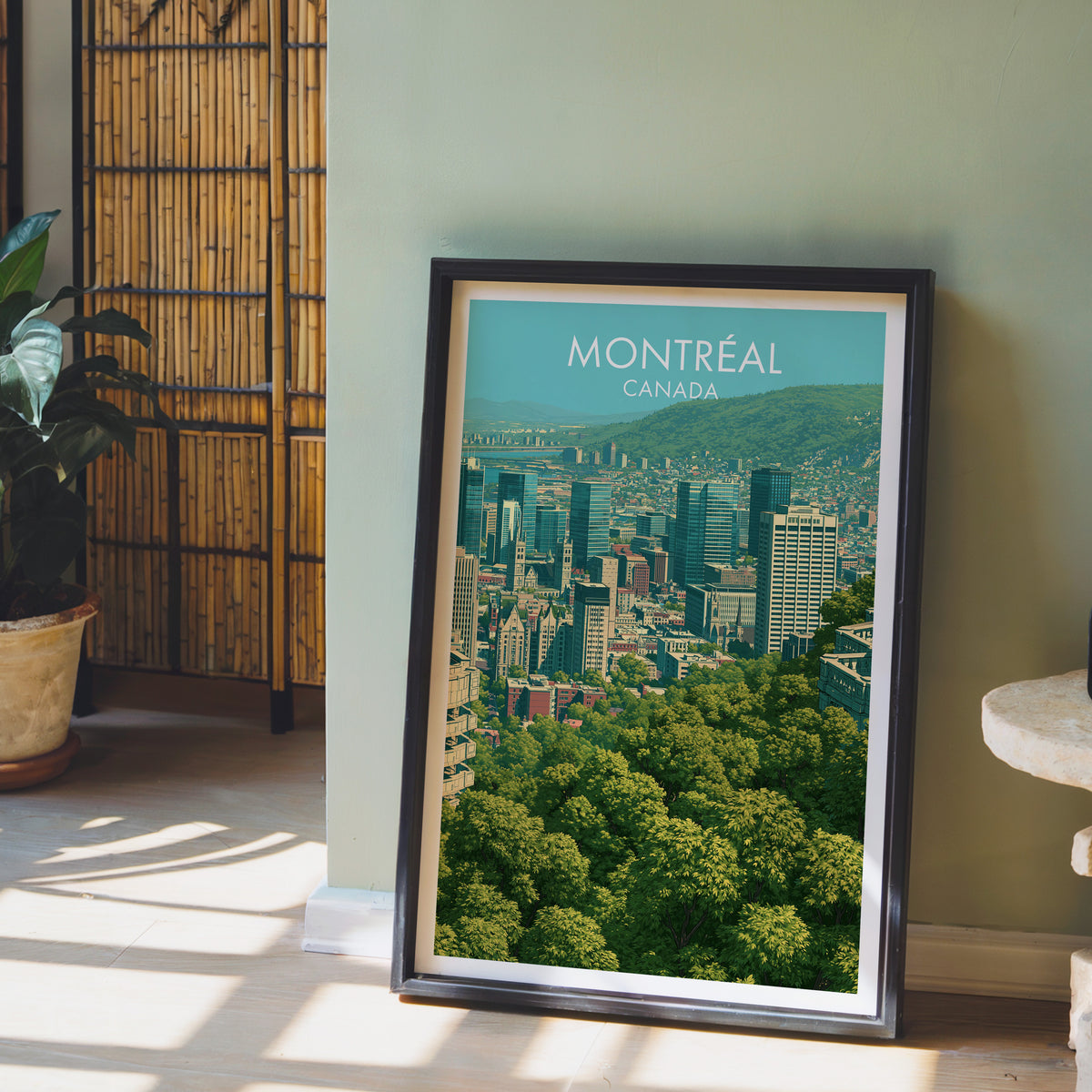 Montreal Quebec travel poster in a black frame on the floor by a sage wall and bamboo screen