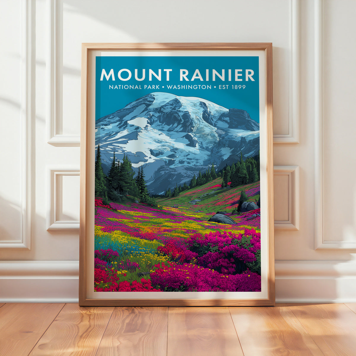 Mount Rainier National Park mid-century modern art print in a light oak frame leaning against a panelled white wall on a wood floor