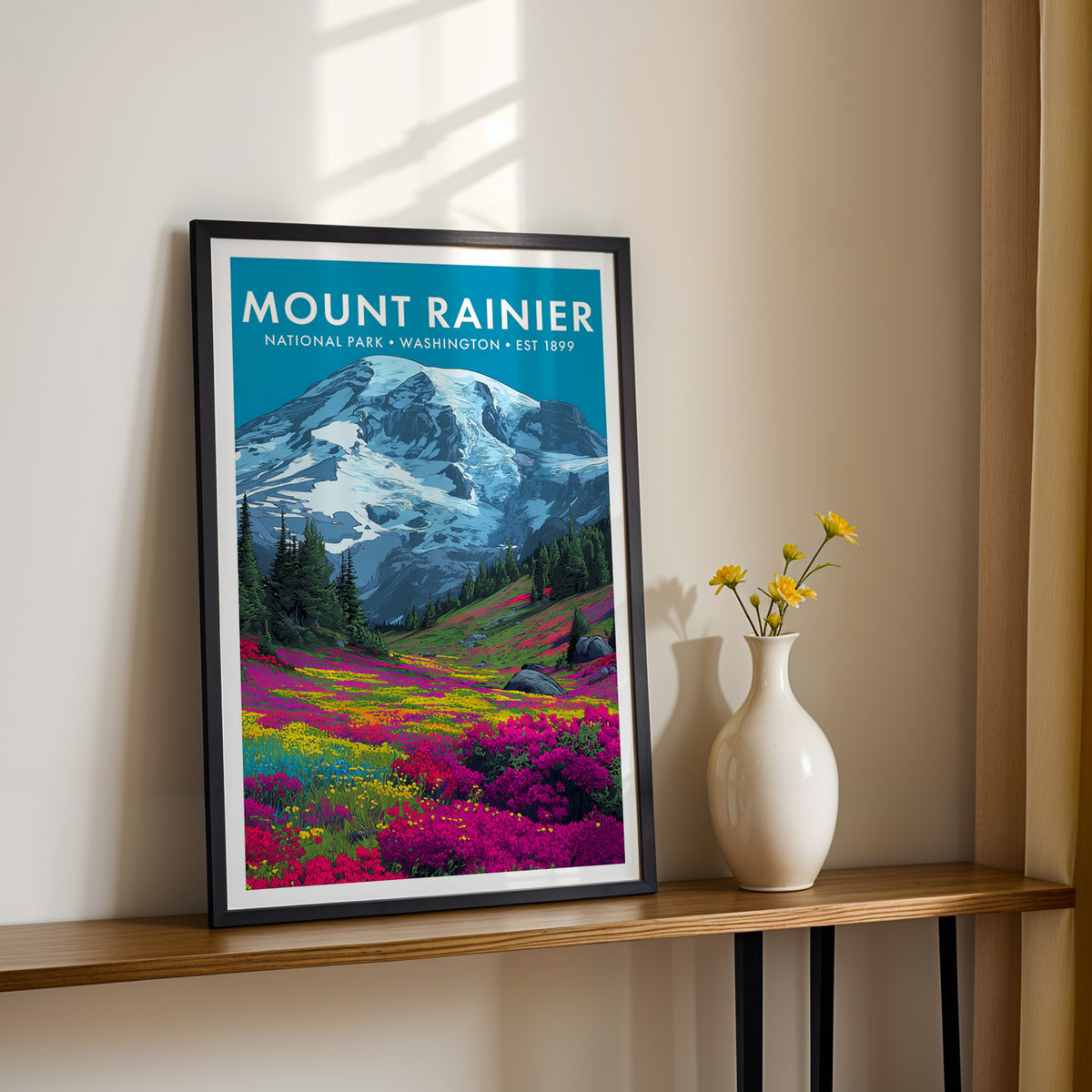 Mount Rainier National Park mid-century modern art print in a slim black frame on a console table beside yellow blooms — hallway wall art