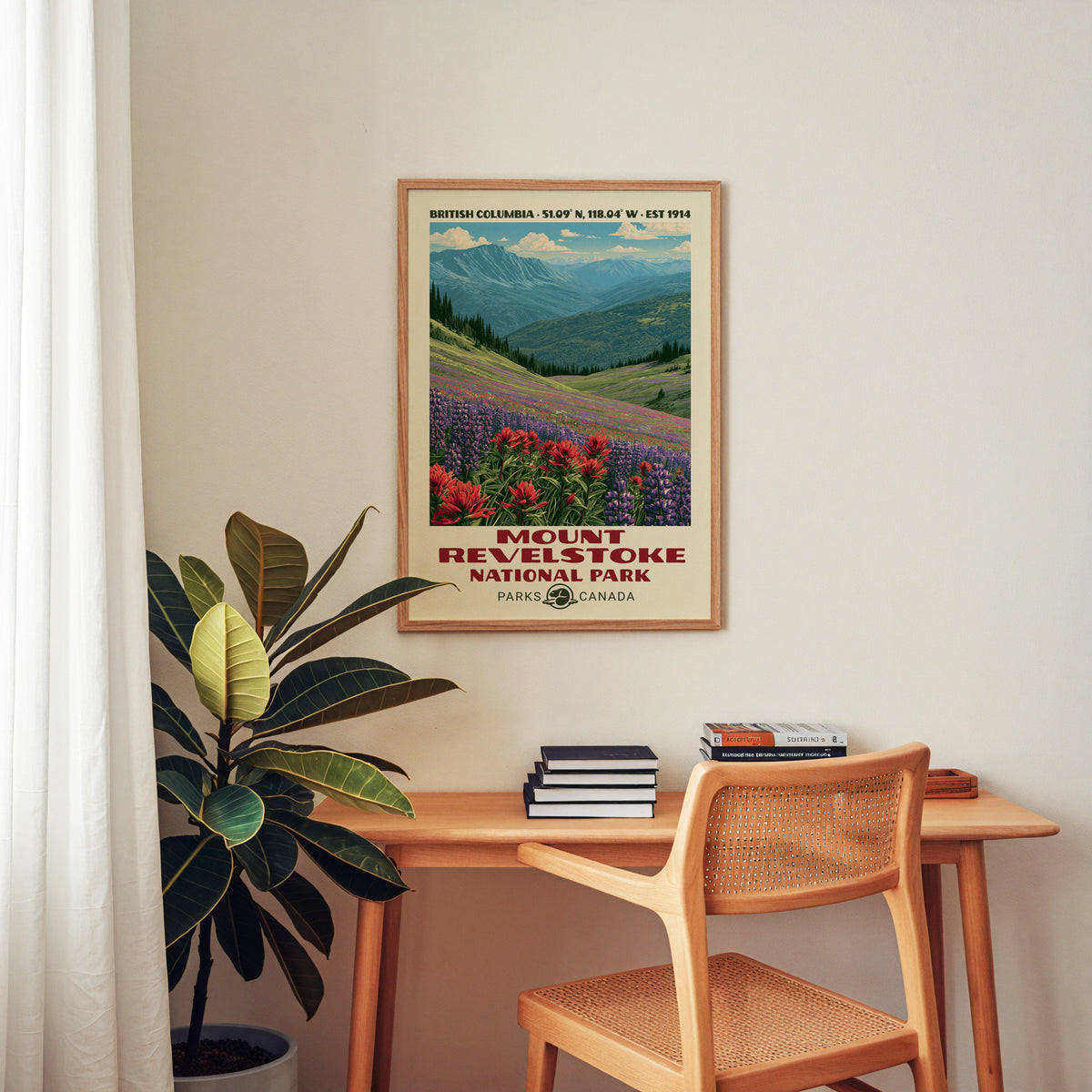 Mount Revelstoke Canada poster in an oak frame above a wood desk with a cane chair