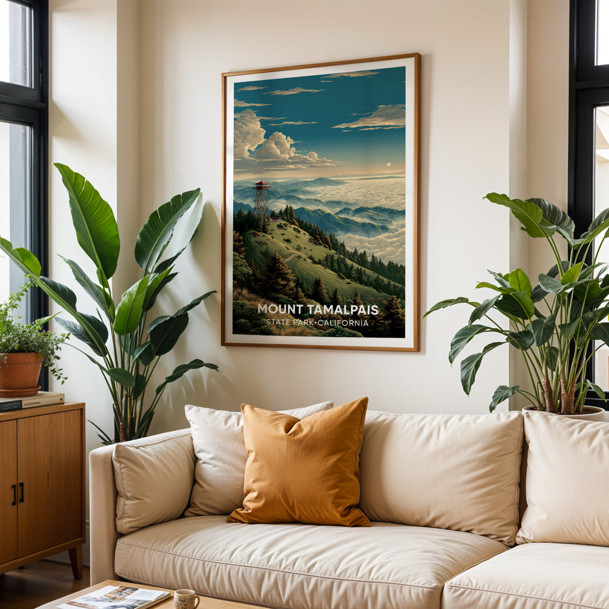 Marin ridge wall art framed above a cream sofa with ochre cushions and two big tropical plants