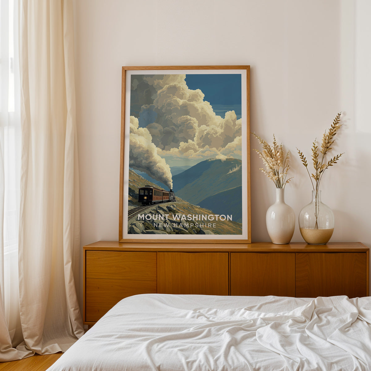 Mount Washington Cog Railway print framed in oak on a teak sideboard beside dried pampas in white vases