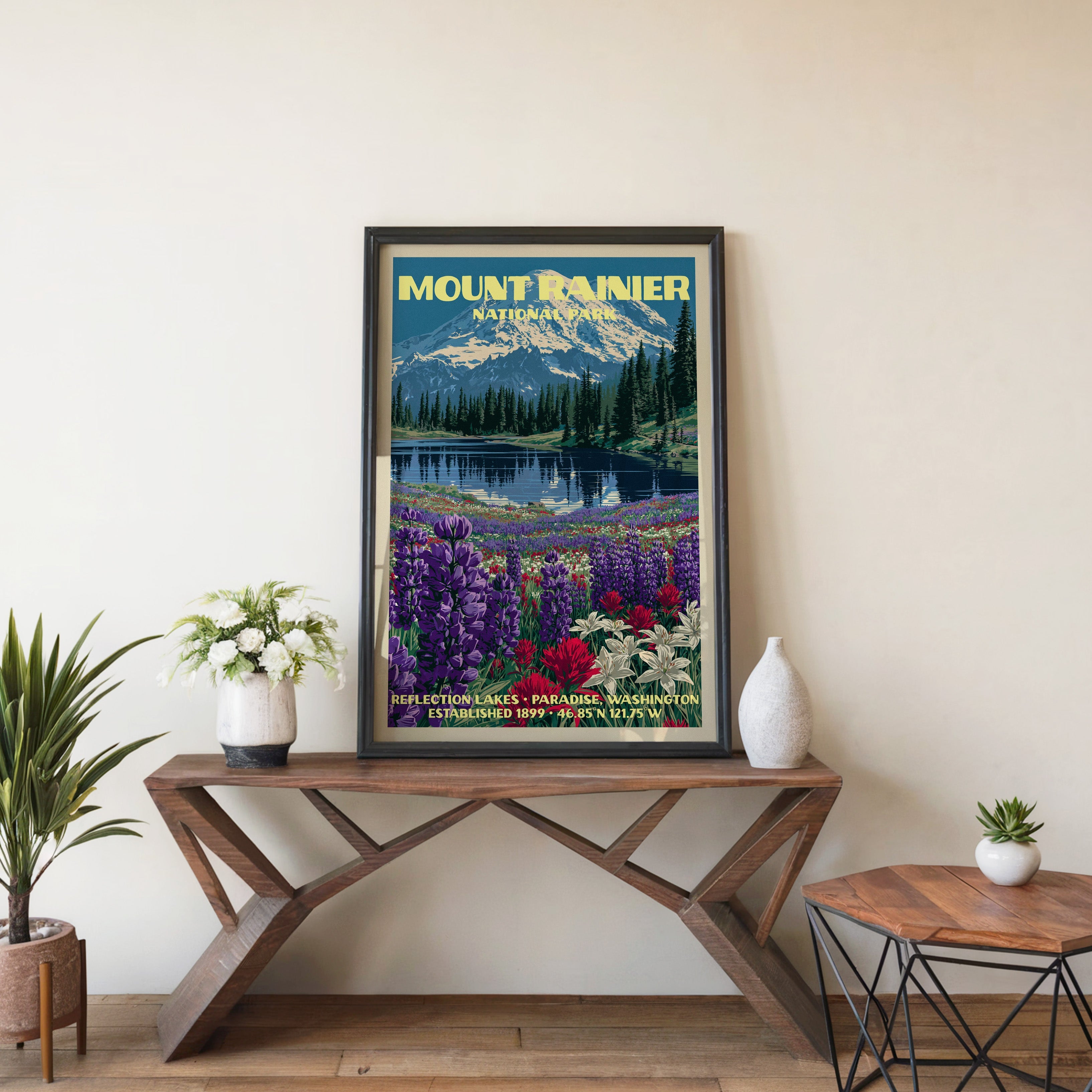 Mount Rainier Reflection Lakes wall art in black, leaning on a walnut console with white anemones and a vase