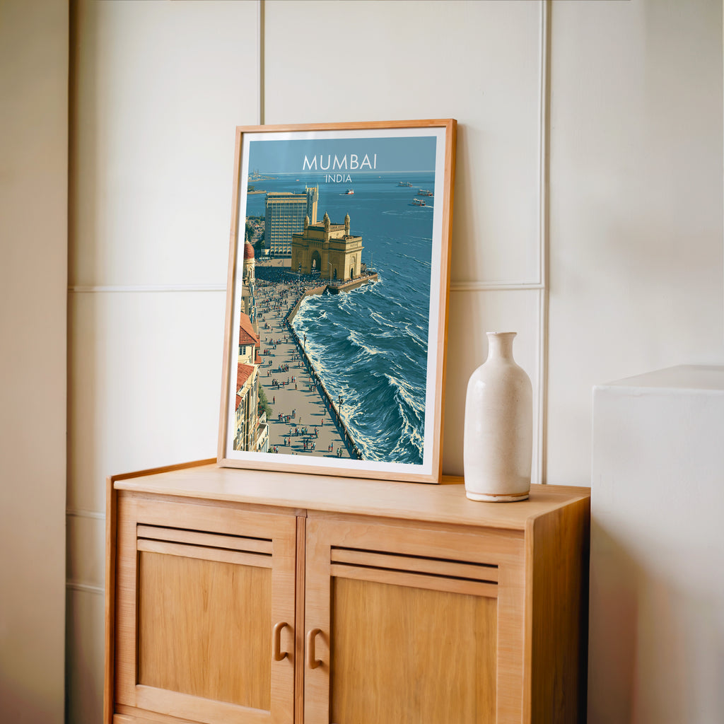 Small Mumbai India travel poster in an oak frame on a mid-century sideboard with a ceramic vase