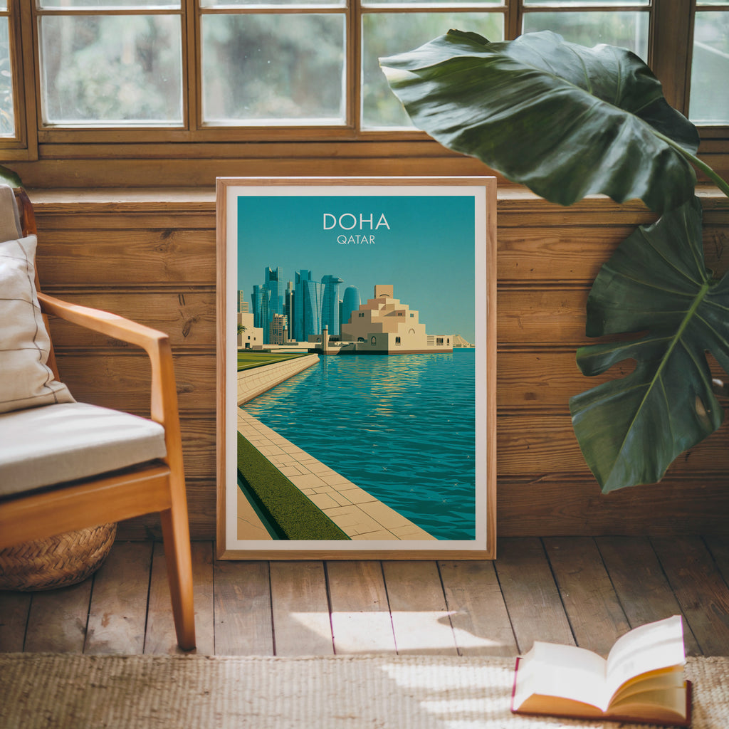 Framed Doha Qatar poster leaning against a timber cabin wall with monstera leaves and an open book
