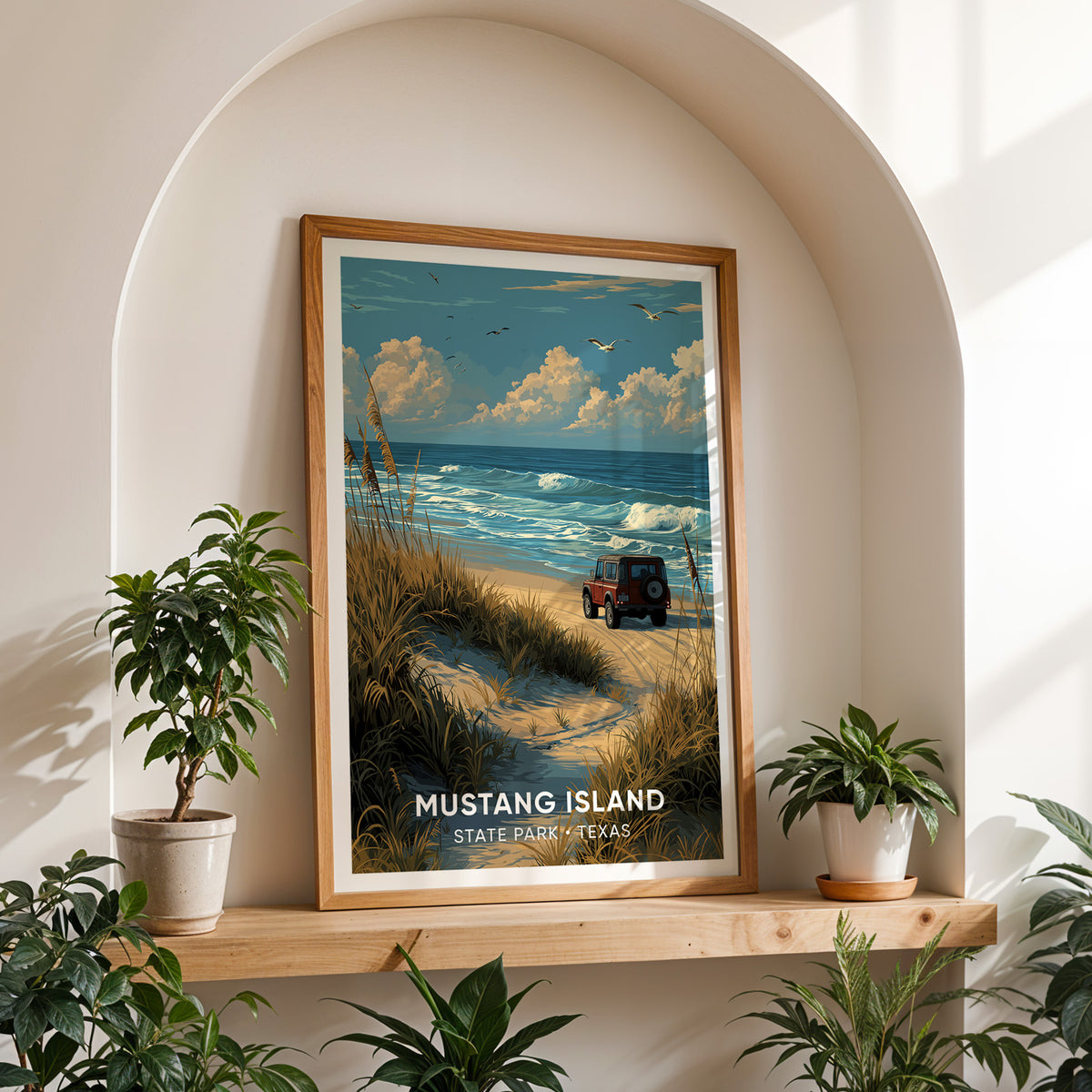 Texas beach canvas print in an oak frame on a shelf in a white arched alcove between potted plants