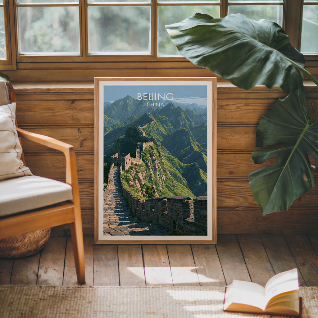 Framed Great Wall of China Beijing poster leaning against a timber cabin wall with monstera leaves and an open book