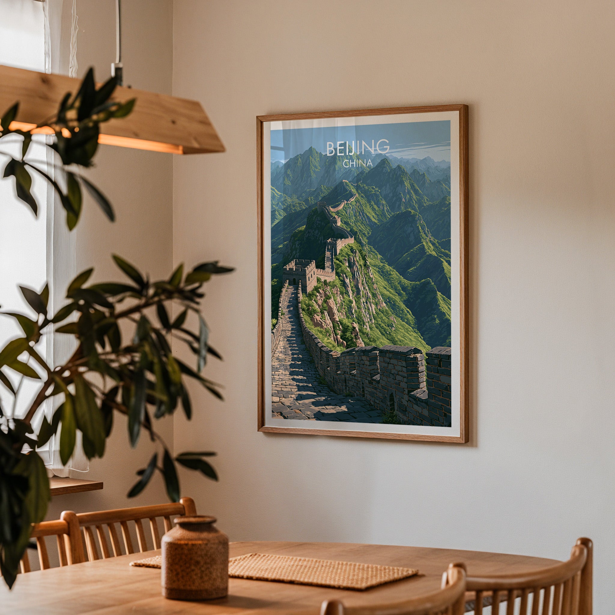 Framed Great Wall of China Beijing print on a dining room wall above an oak table in warm afternoon light