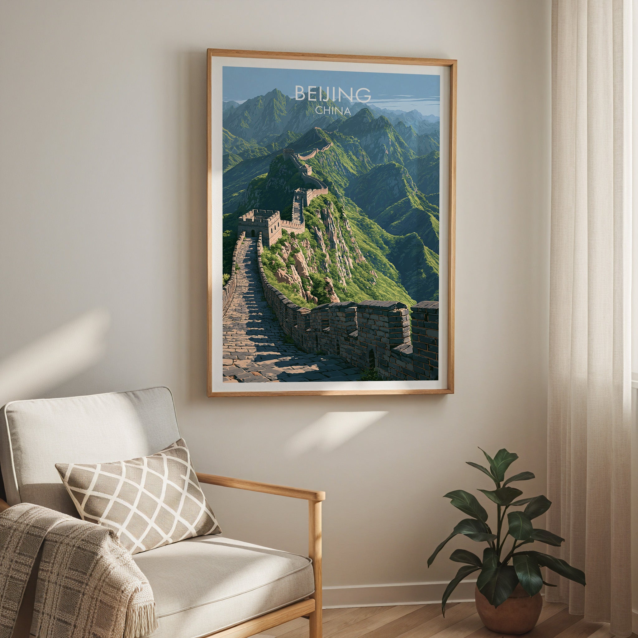 Great Wall of China Beijing travel print in a light oak frame on a living room wall beside a linen armchair