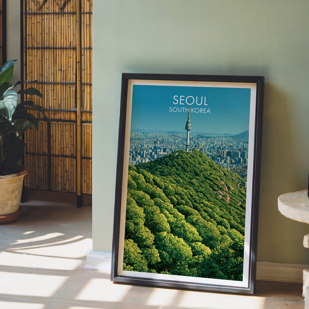N Seoul Tower Seoul Korea wall art in a black frame leaning against a sage green wall beside a bamboo screen