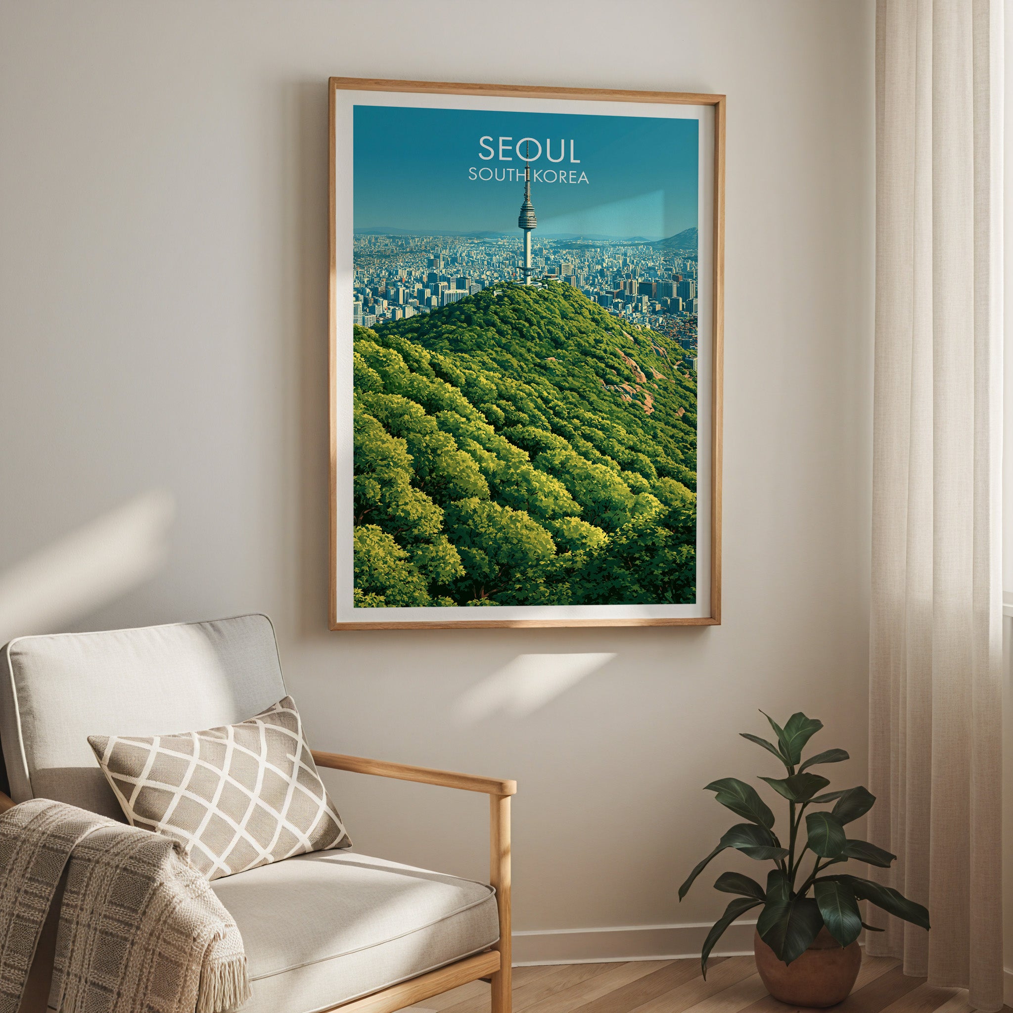 N Seoul Tower Seoul Korea travel print in a light oak frame on a living room wall beside a linen armchair
