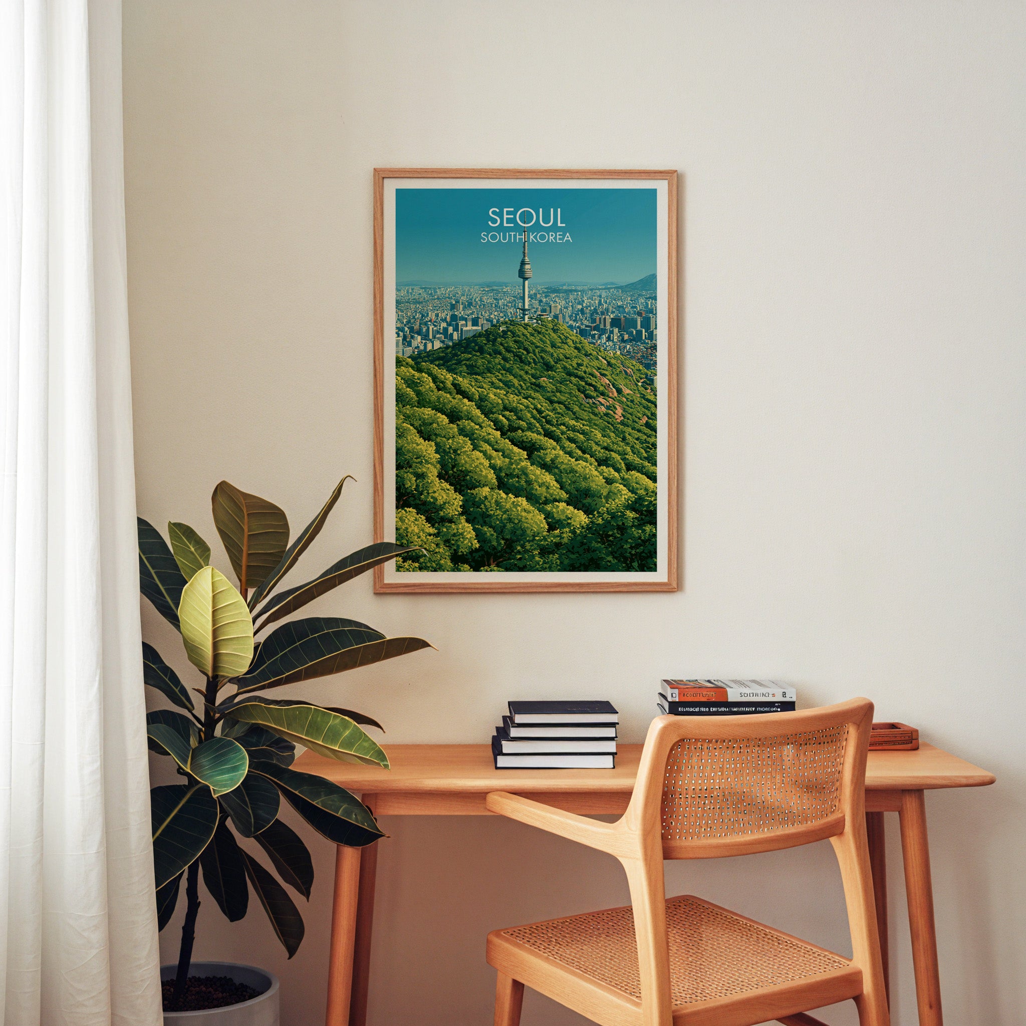 N Seoul Tower Seoul Korea wall art above a wooden home office desk with a rattan chair and books