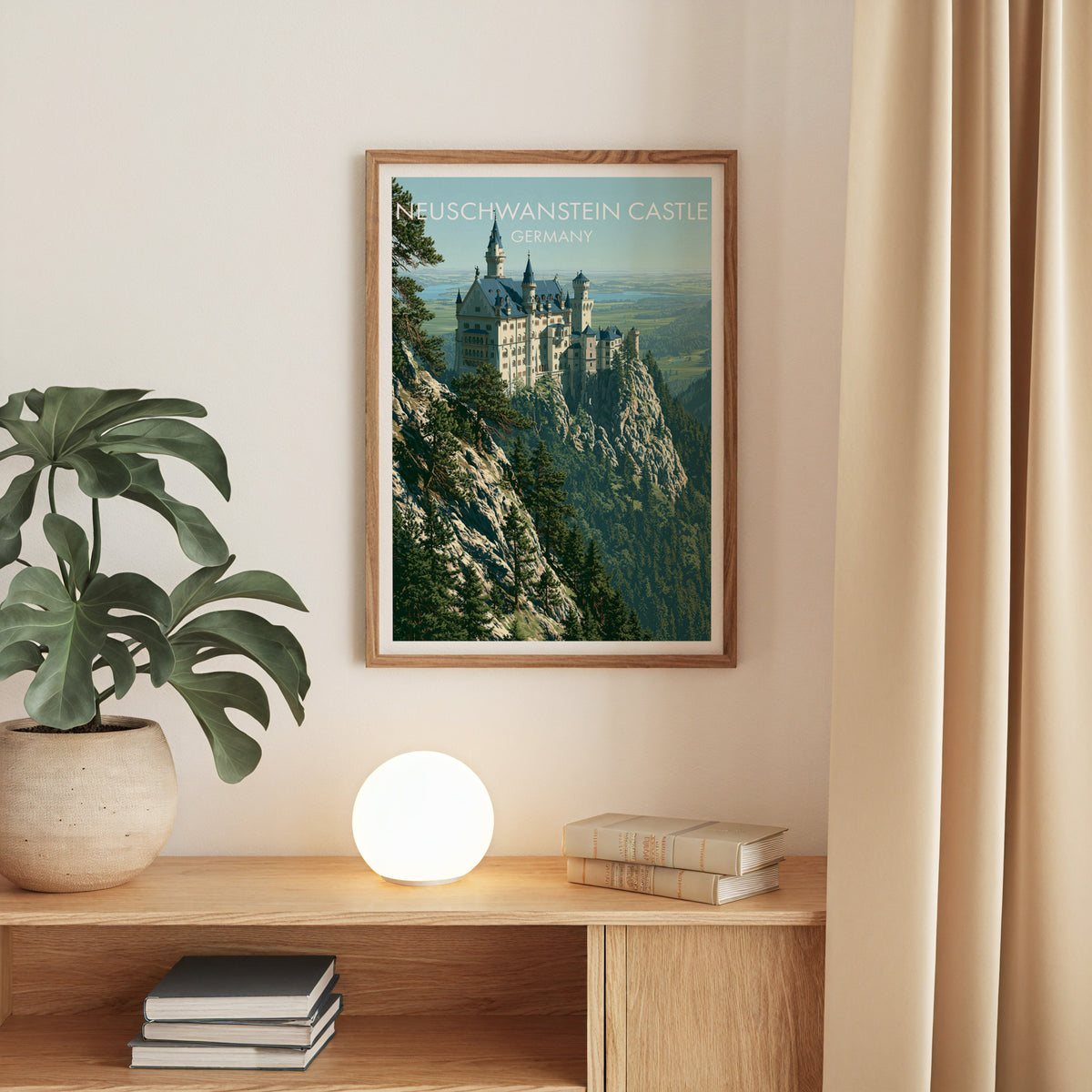 Neuschwanstein Castle print, oak frame above an oak console with a monstera and a round globe lamp