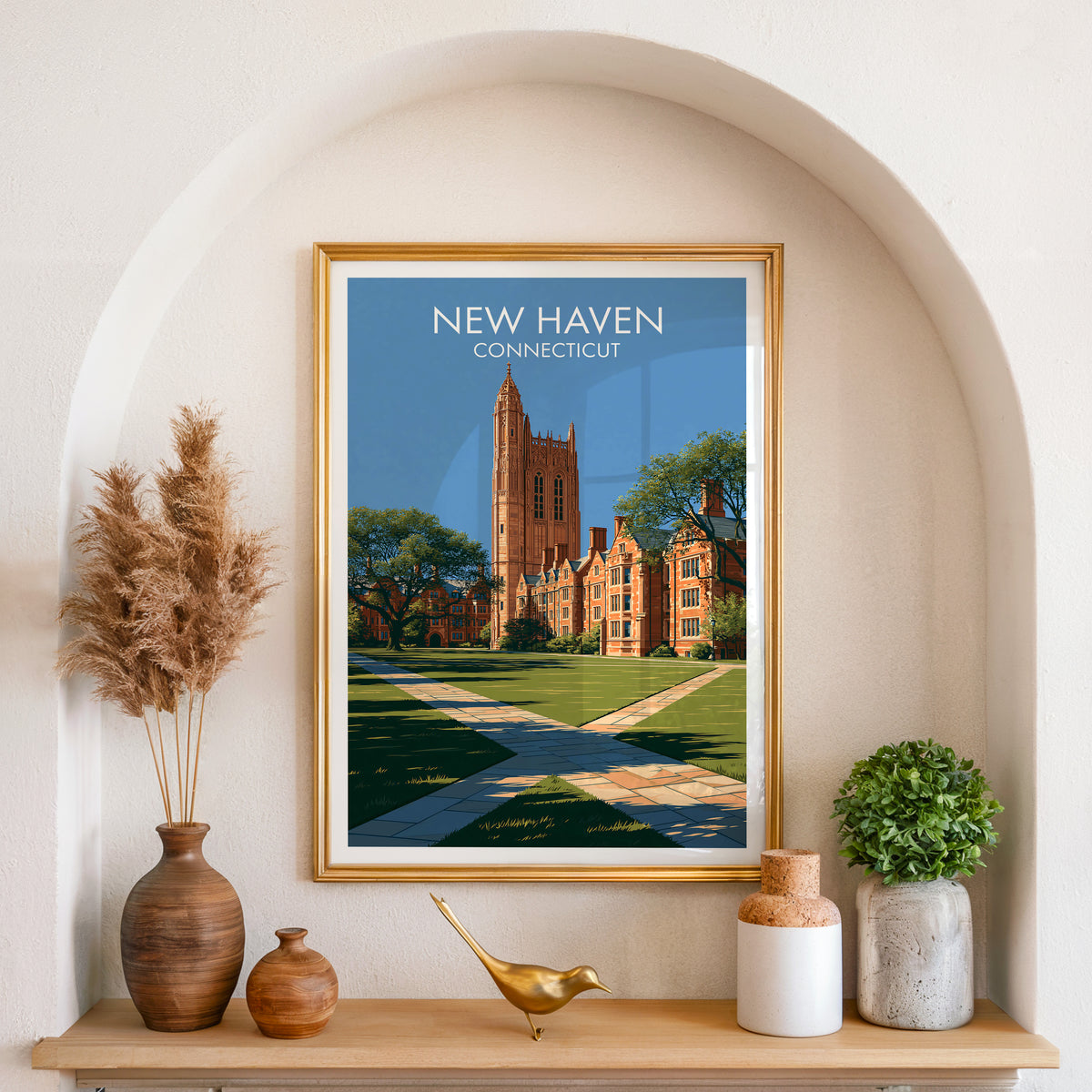 New Haven Connecticut art in a gold frame in an arched wall niche with pampas grass and a brass bird