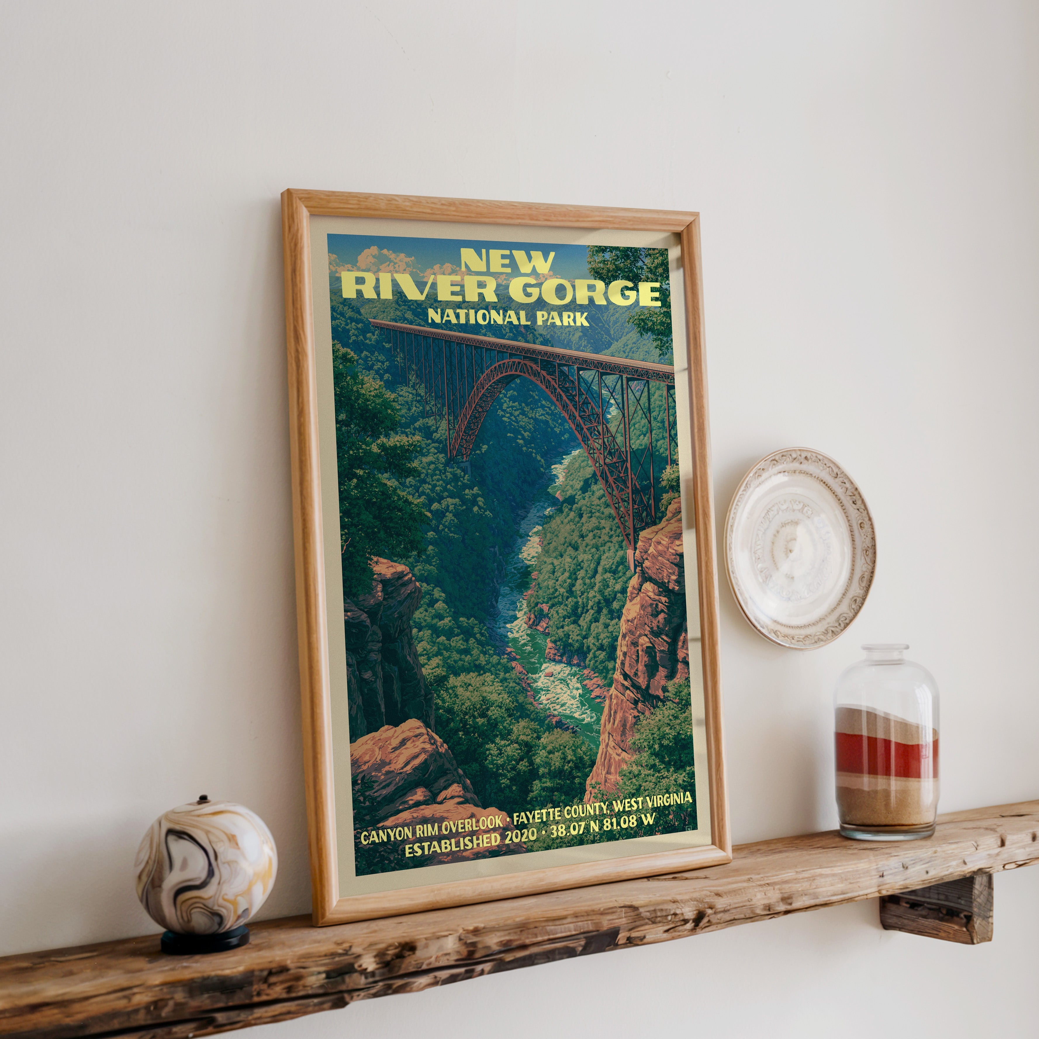 New River Gorge print in oak, leaning on a reclaimed wood ledge with a marbled stone sphere and sand jar