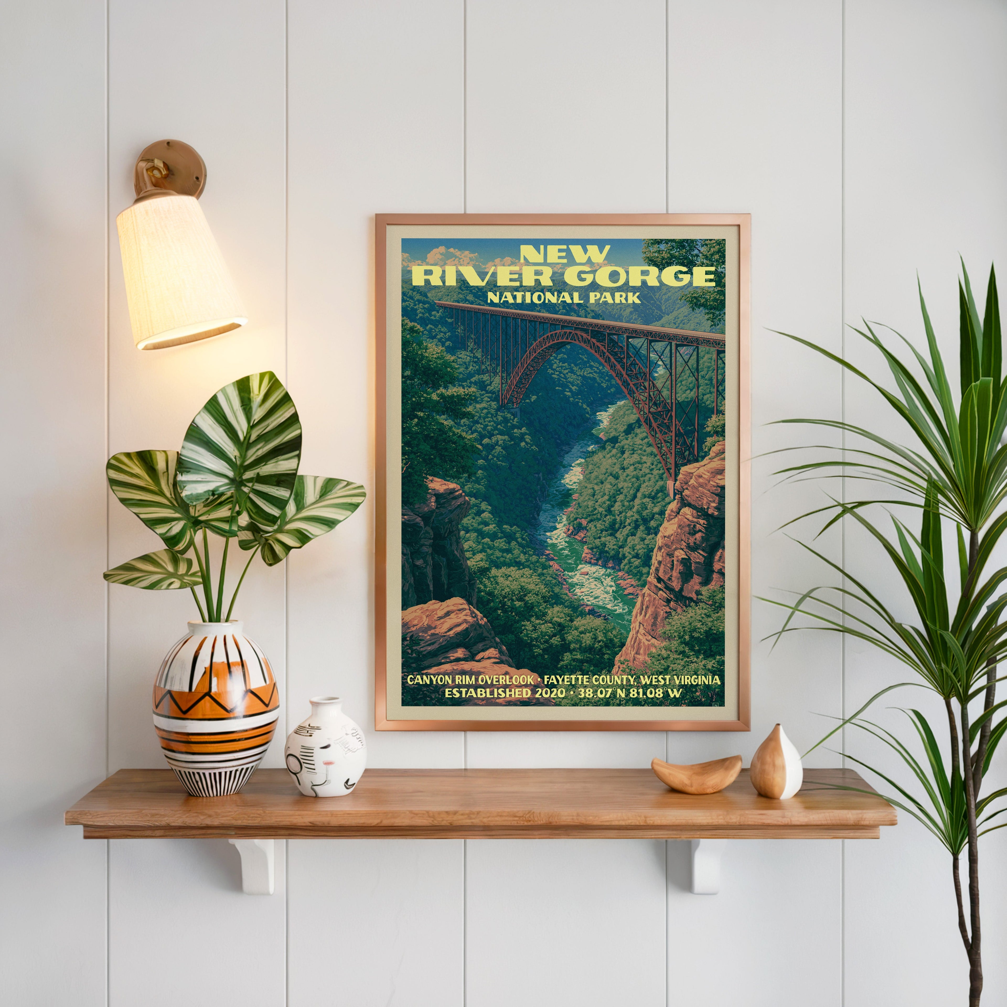 Canyon Rim Overlook print framed on white panelling above an oak shelf with a patterned vase and brass sconce