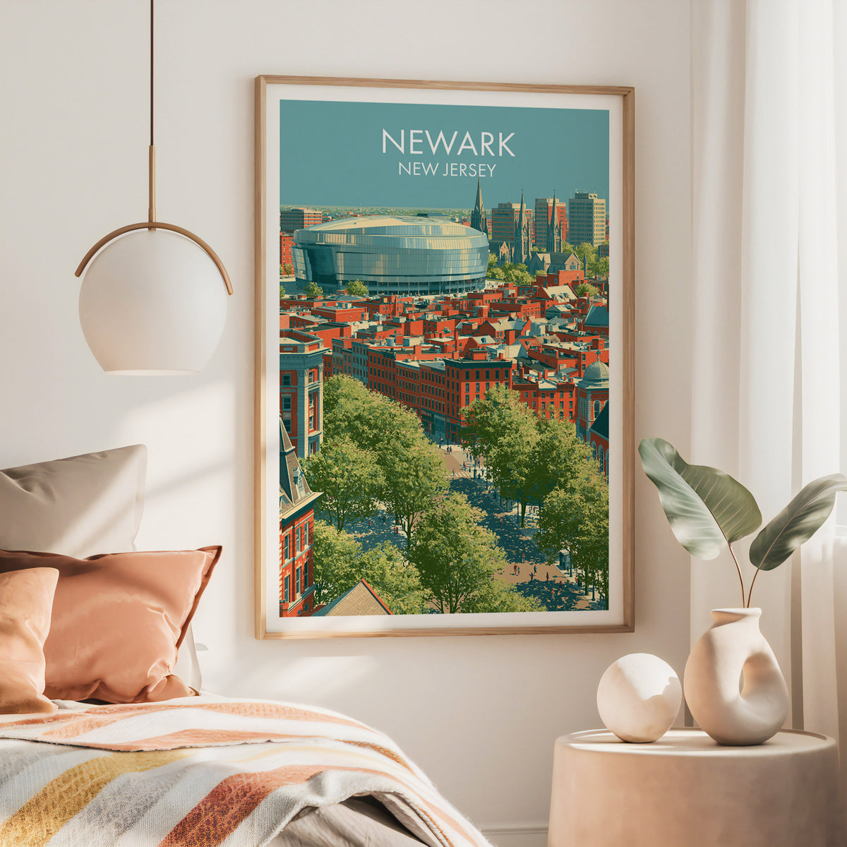 Large oak framed Newark New Jersey artwork above a bed with a rust throw and a brass pendant lamp
