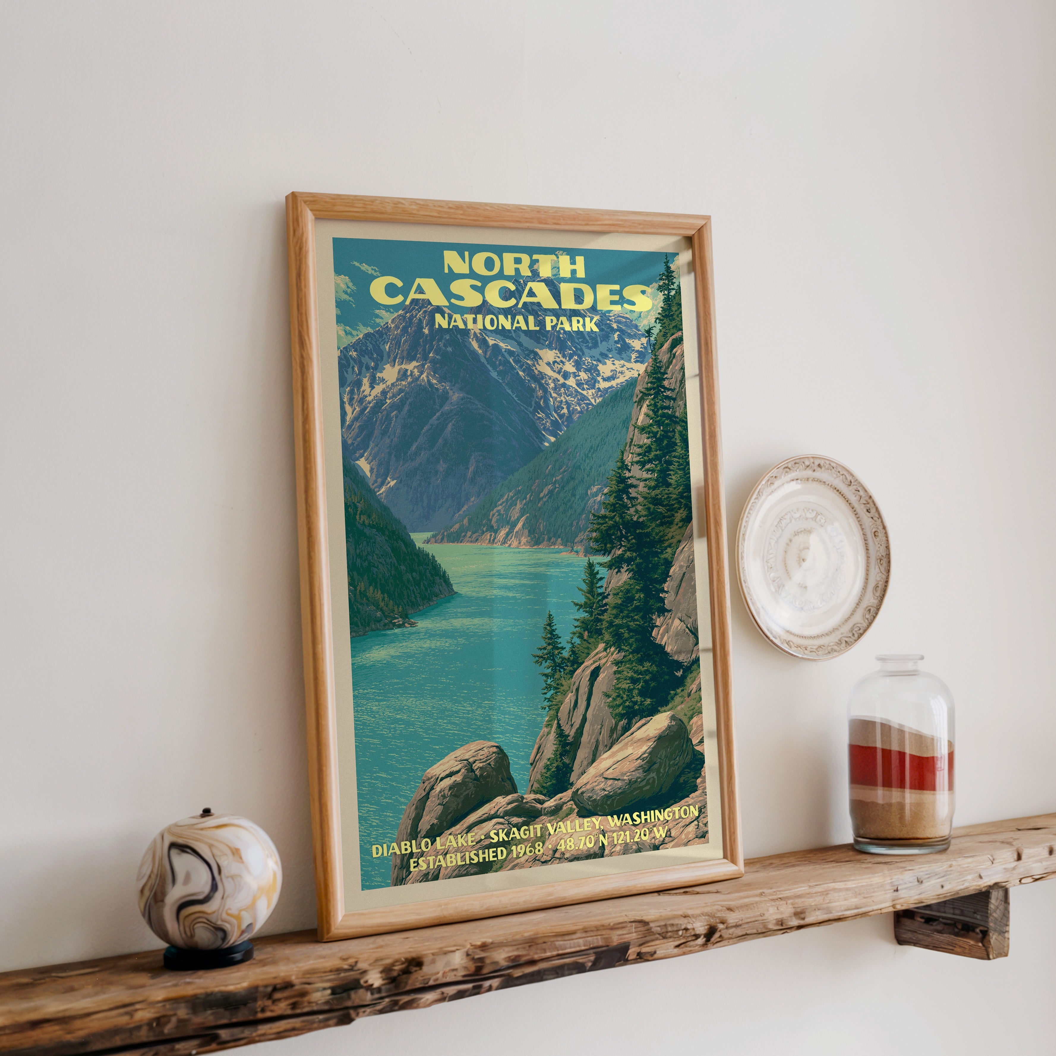 North Cascades Diablo Lake print in oak, leaning on a reclaimed wood ledge with a marbled sphere and sand jar