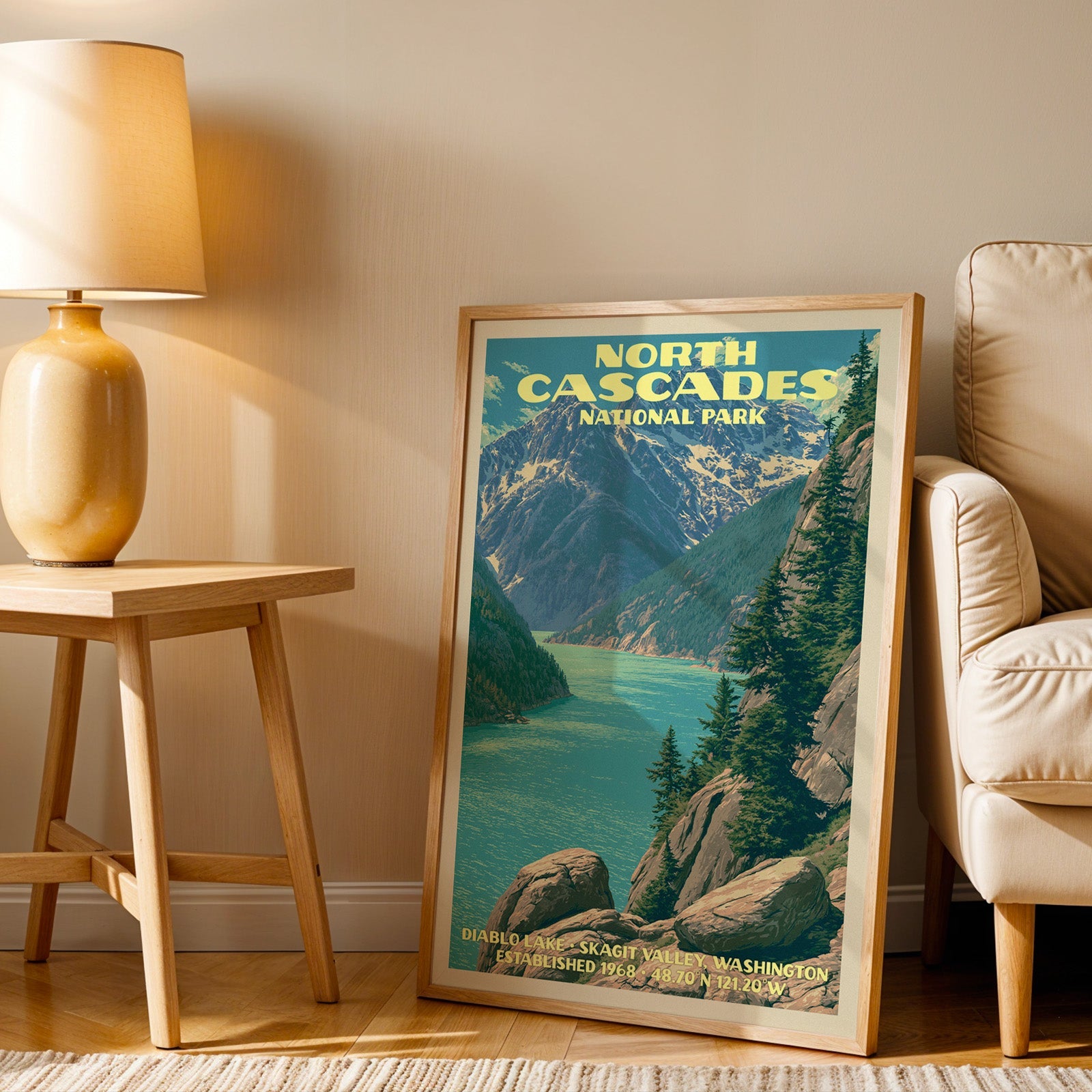 Diablo Lake North Cascades wall art in oak, leaning by an armchair and a side table with an ochre lamp
