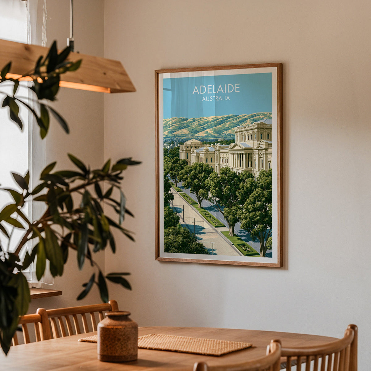 Adelaide poster in an oak frame in a dining corner with an oak table, spindle chairs and pendant light