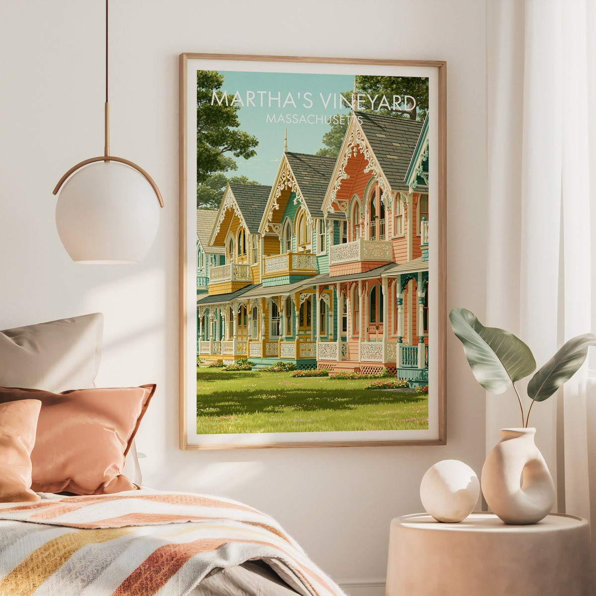 Large oak-framed Martha's Vineyard print above a bed with rust blanket, brass pendant lamp and cream side table.