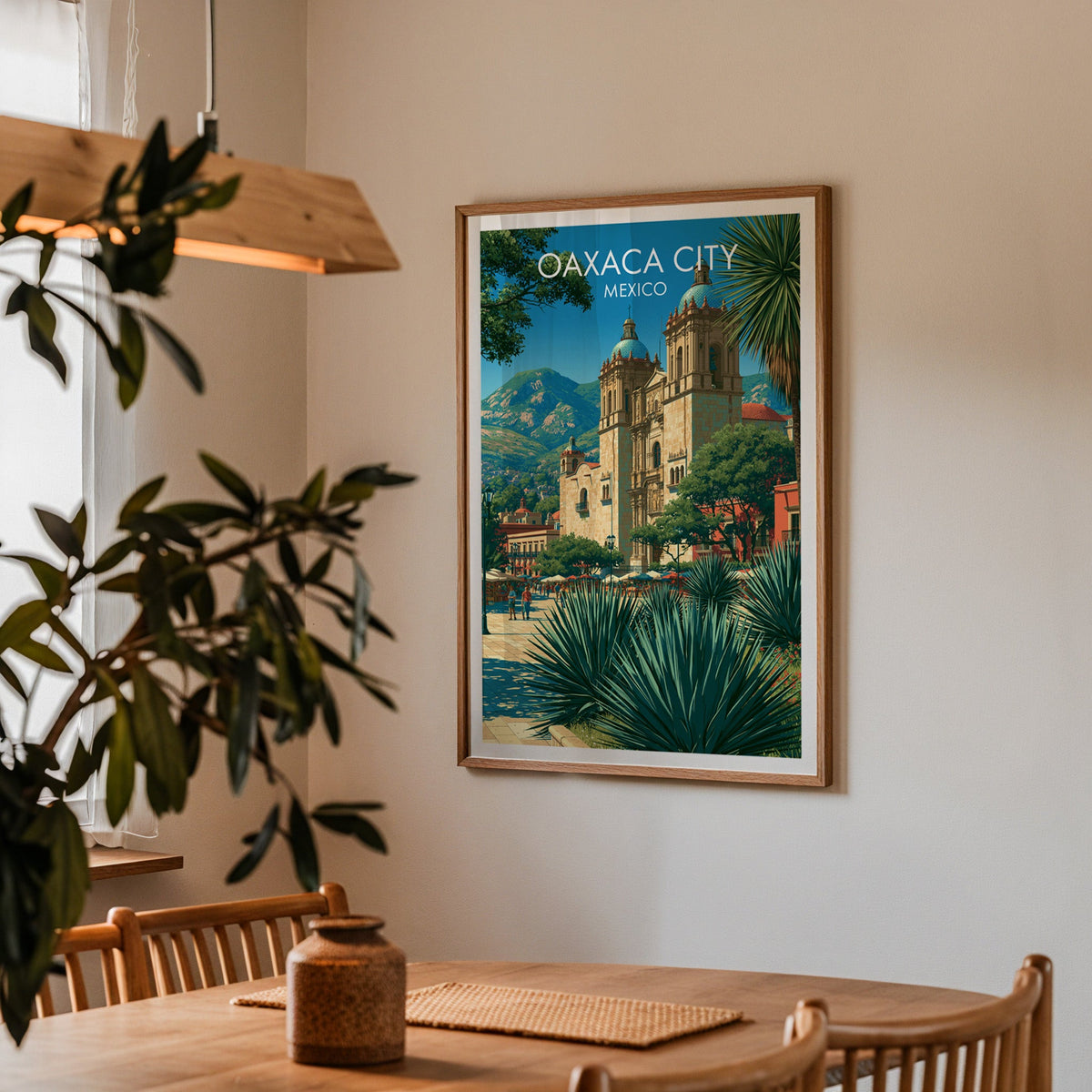 Mexican plaza poster in an oak frame in a dining corner with oak table, spindle chairs and pendant lamp