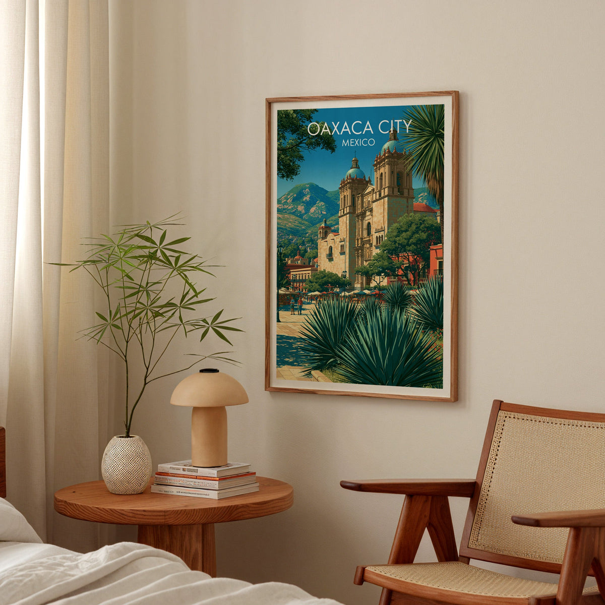 Green and honey valley scene in an oak frame above a bedside table with a mushroom lamp and bamboo stems