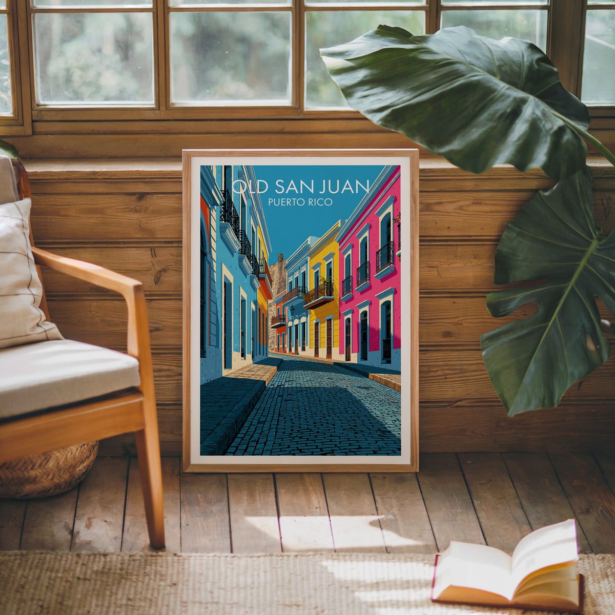 Puerto Rico street art in an oak frame leaning on a pine cabin wall with a wooden armchair and a monstera leaf