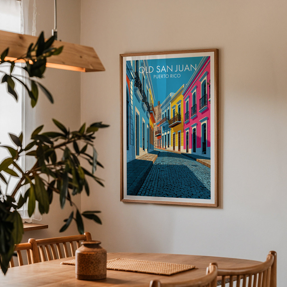 Blue adoquin cobbles print in an oak frame in a dining corner with an oak table and a wood pendant lamp