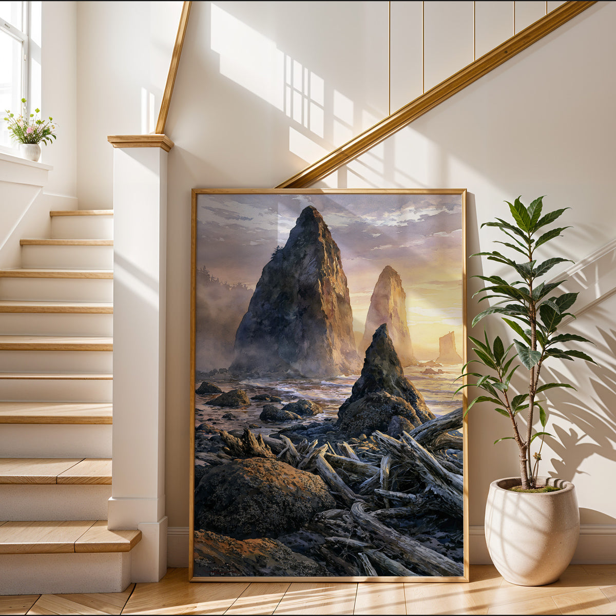 Gold-framed Olympic National Park watercolor art print leaning in a sunlit entryway beside a staircase