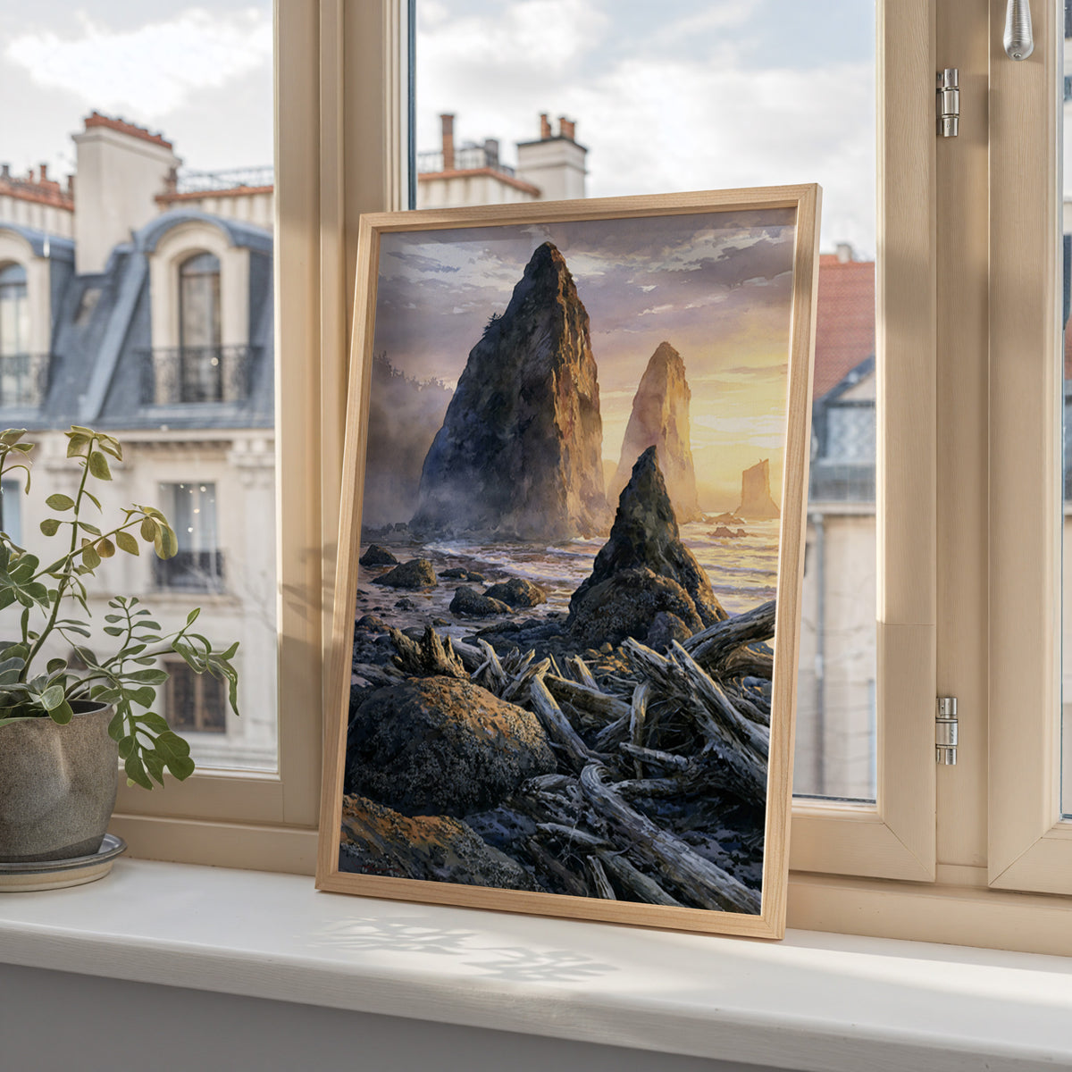 Olympic National Park watercolor art print in a wood frame on a windowsill overlooking city rooftops