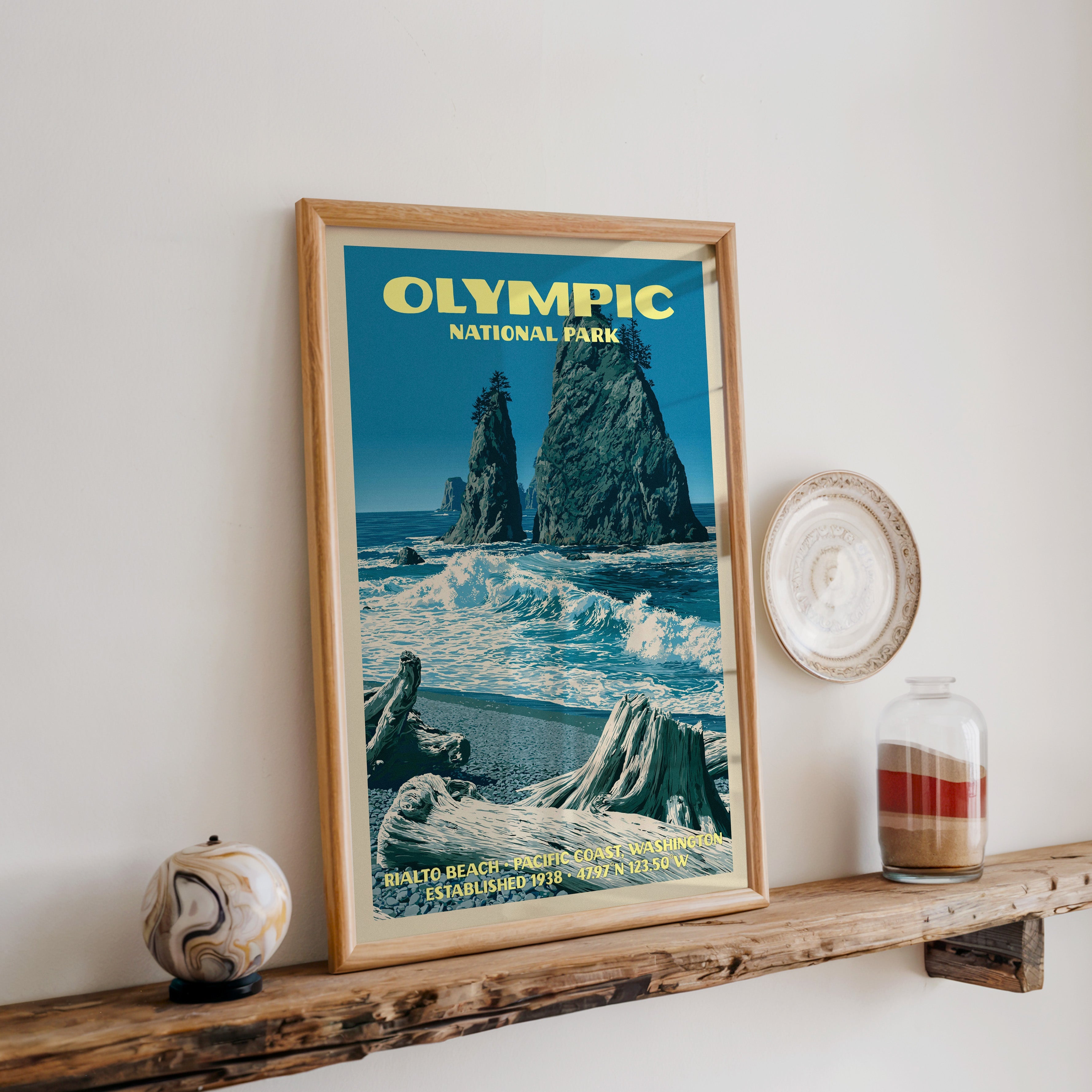 Olympic Rialto Beach print in oak, leaning on a reclaimed wood ledge with a marbled sphere and sand jar