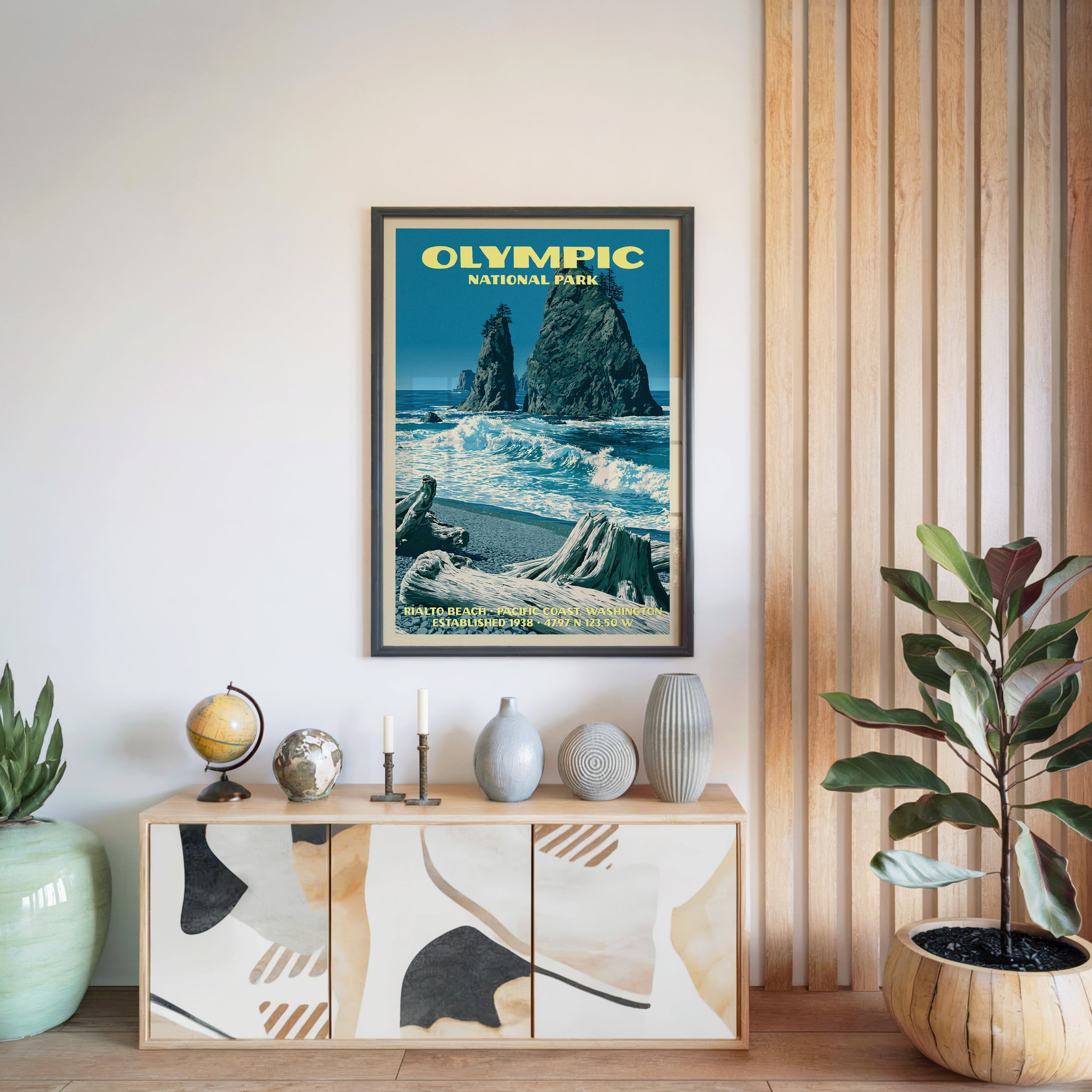 Olympic National Park poster in a black frame above a light wood sideboard by a slatted wall panel