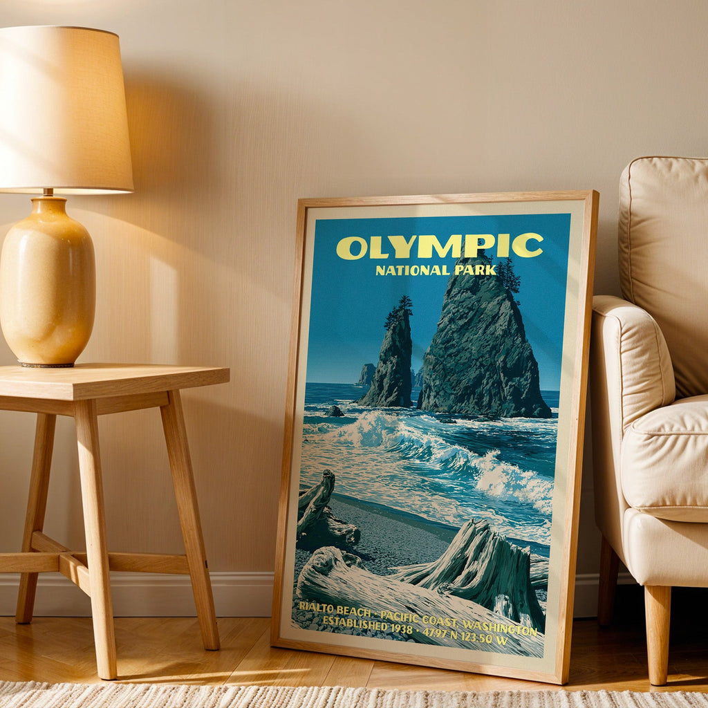 Rialto Beach Olympic wall art in oak, leaning by an armchair and a side table with an ochre ceramic lamp