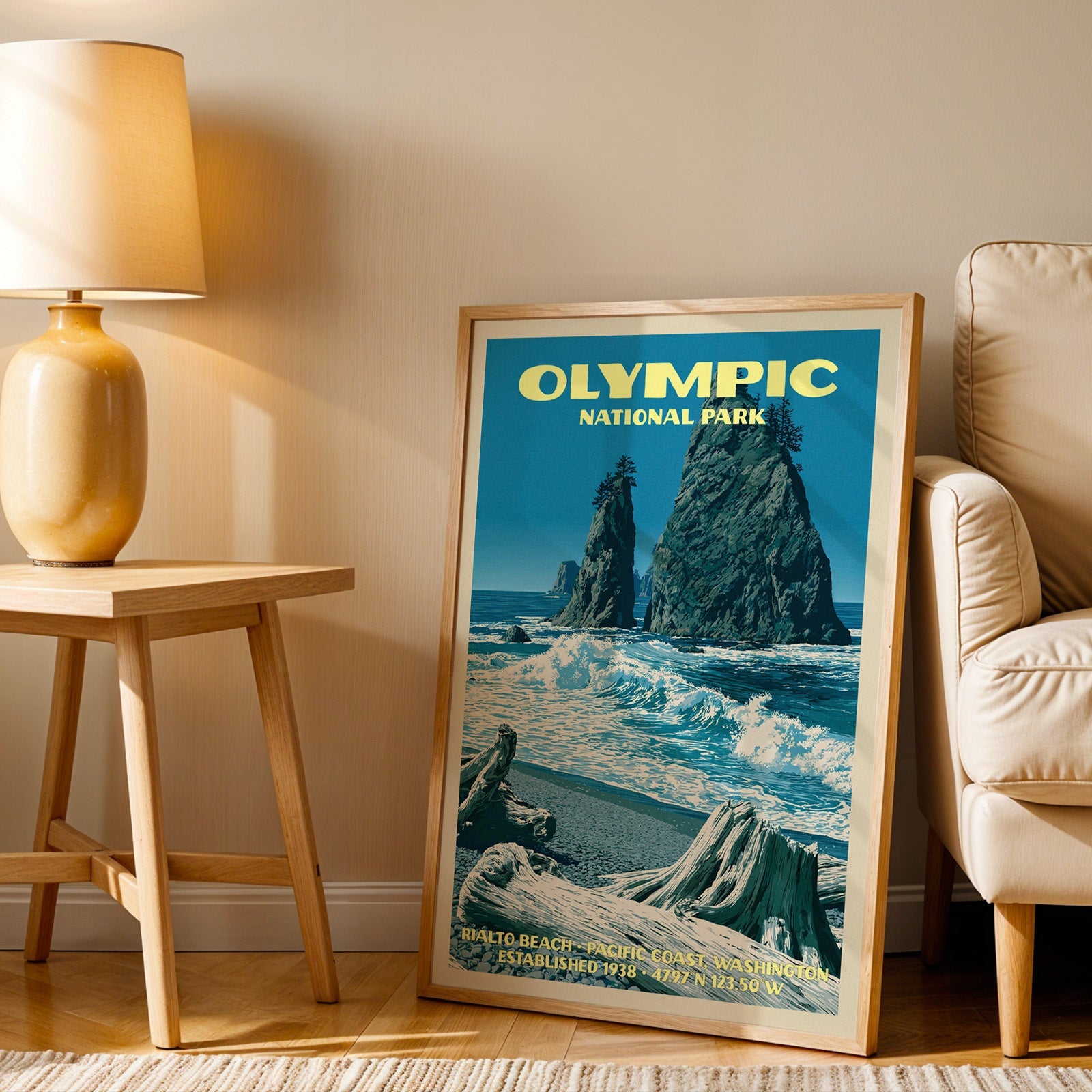 Rialto Beach Olympic wall art in oak, leaning by an armchair and a side table with an ochre ceramic lamp