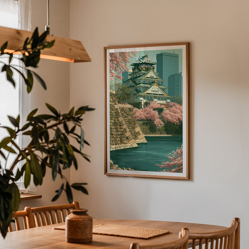 Framed Osaka Castle Japan print on a dining room wall above an oak table in warm afternoon light